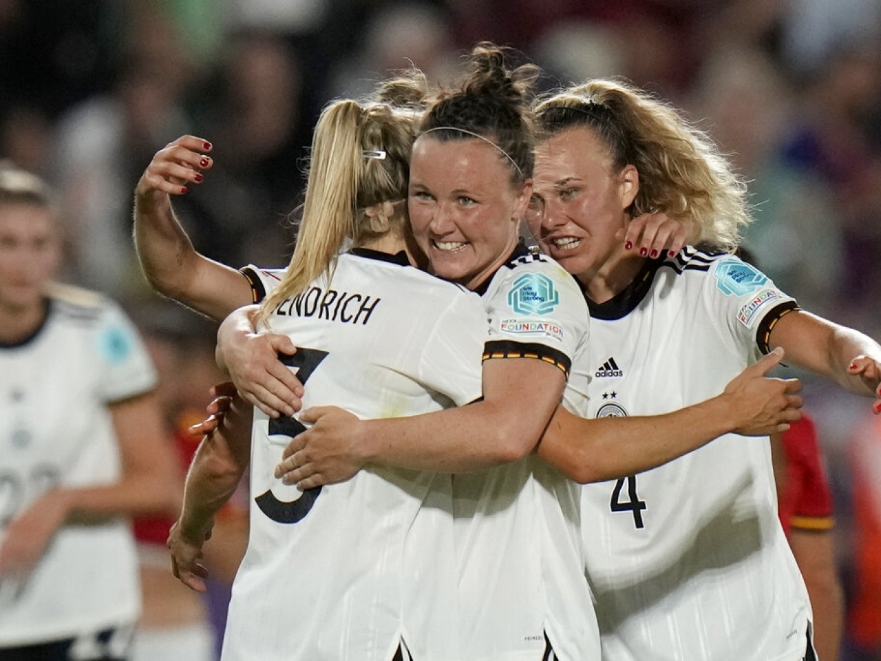 Germany's Kathrin-Julia Hendrich, Marina Hegering and Lena Lattwein, from left to right, celebrate after their 2-0 win over Spain at Brentford Community Stadium in London. Photo: AP