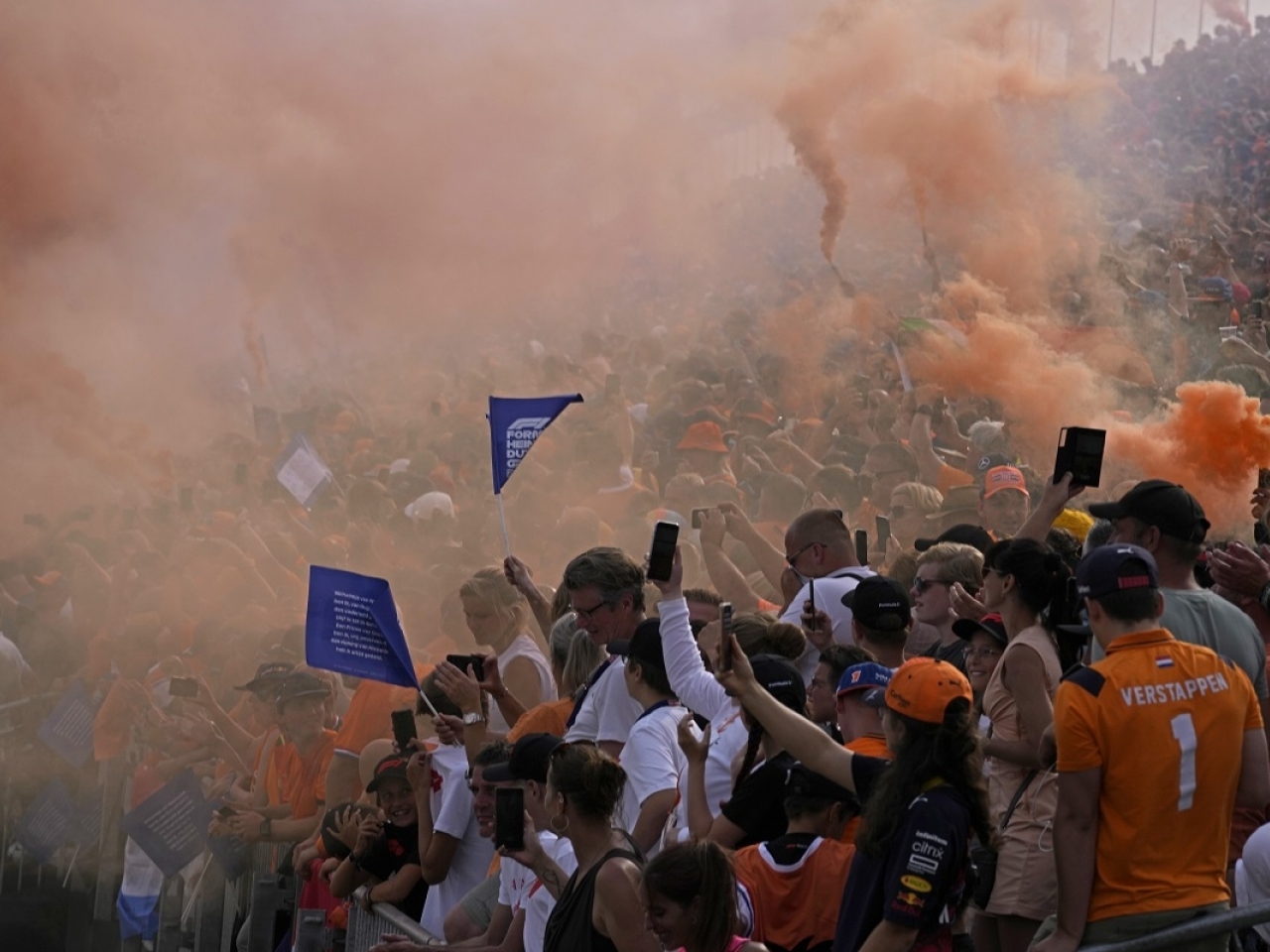 Fans release orange smoke bombs to celebrate after Red Bull driver Max Verstappen won the Formula One Dutch Grand Prix. Photo: AP