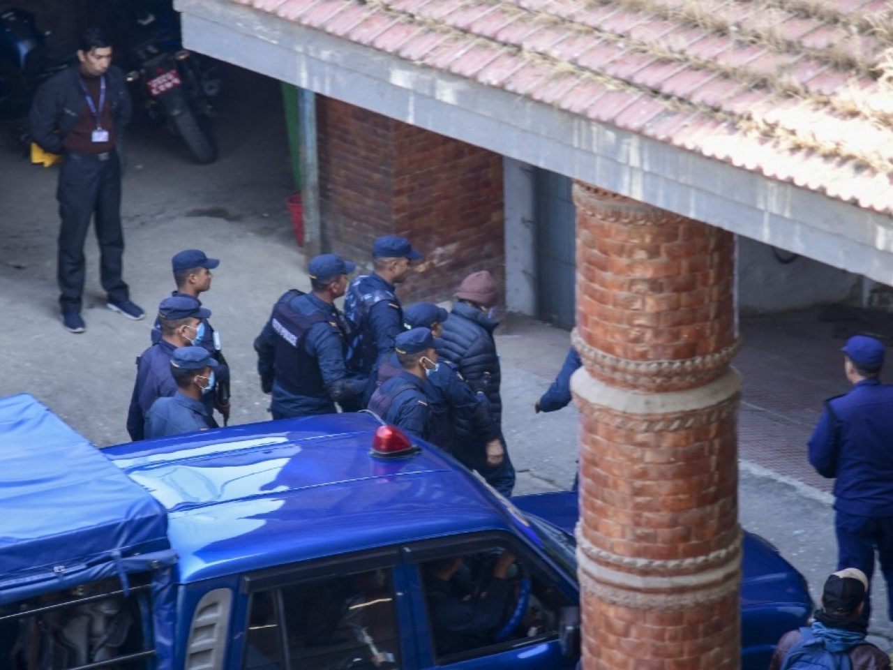 Charles Sobhraj was taken to immigration detention where he was escorted inside wearing a  brown woolly hat ringed by police in bulletproof jackets. Photo: AFP