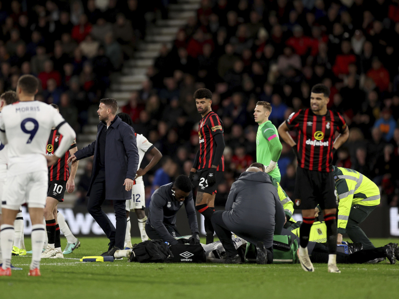 Luton Town manager Rob Edwards on the pitch as his player Tom Lockyer receives treatment. Photo: AP