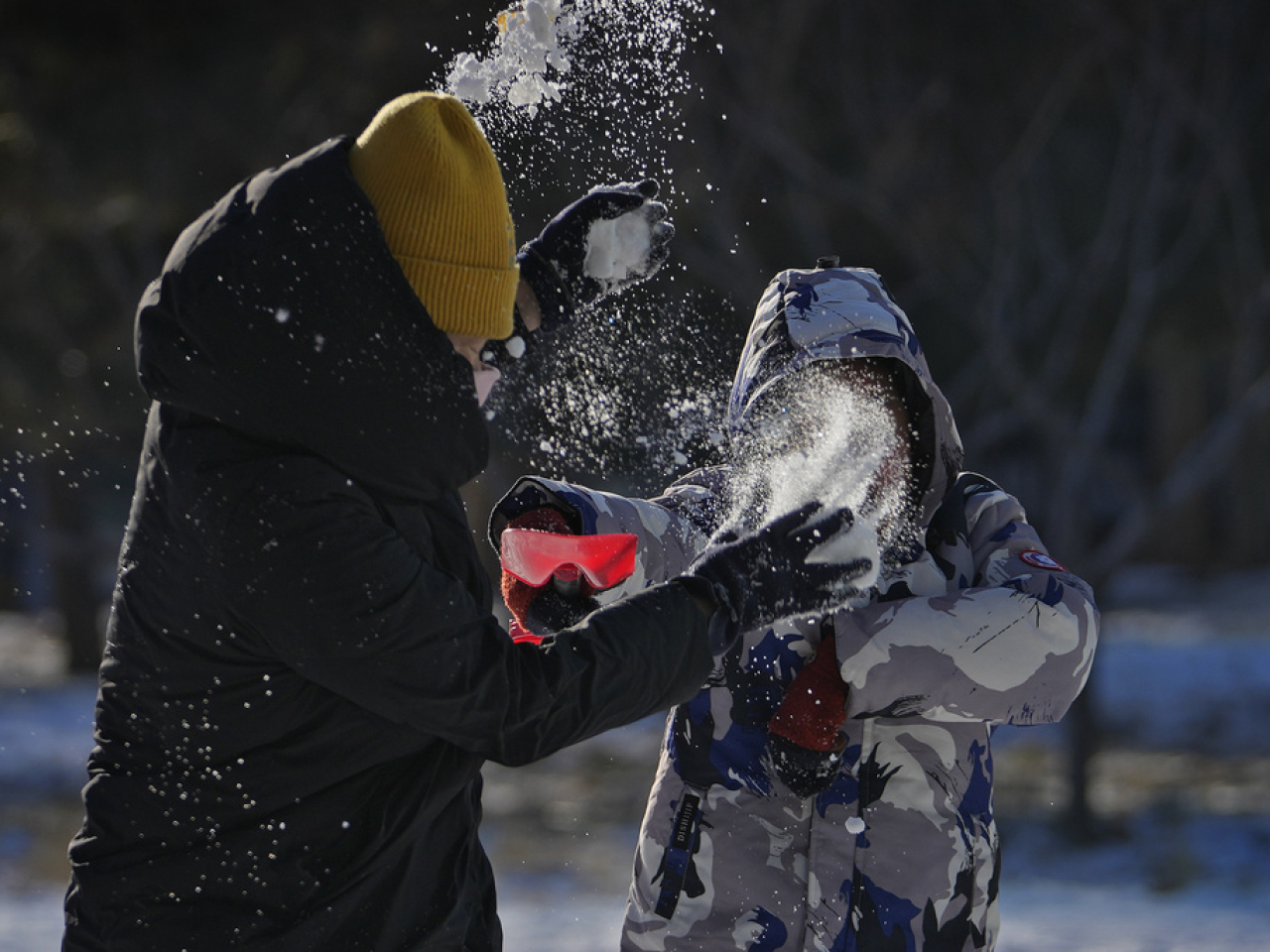 Beijing residents make the most of the snow during the capital's longest cold snap since records began. Photo: AP