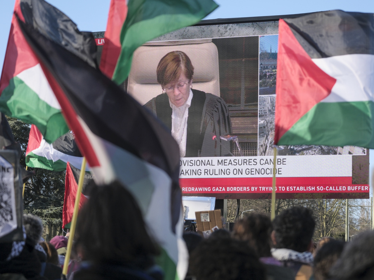 示威者在荷蘭海牙國際法院外揮舞旗幟。（美聯社）