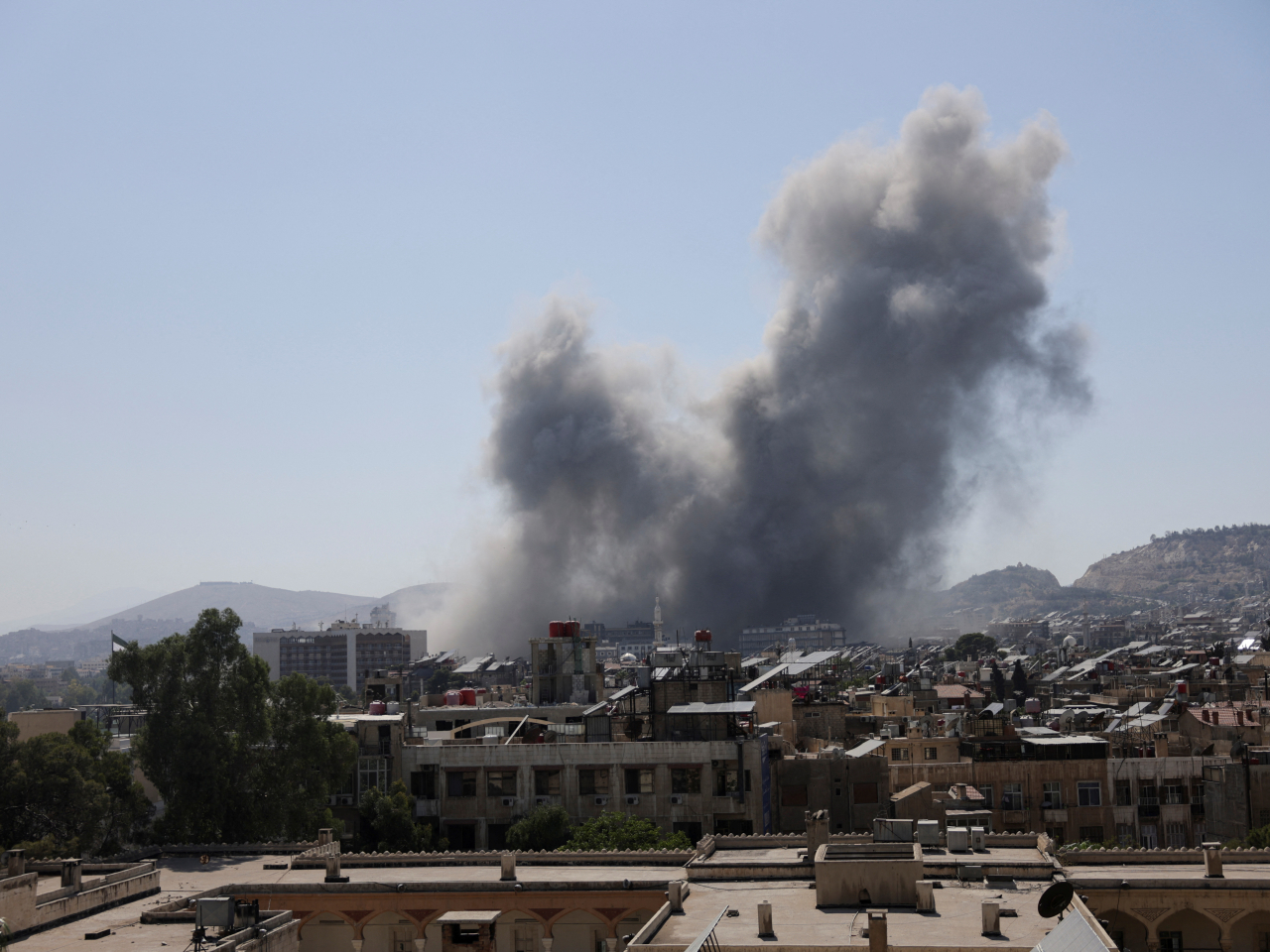 Smoke rises after strikes on Syria's defense ministry in Damascus. Photo: Reuters