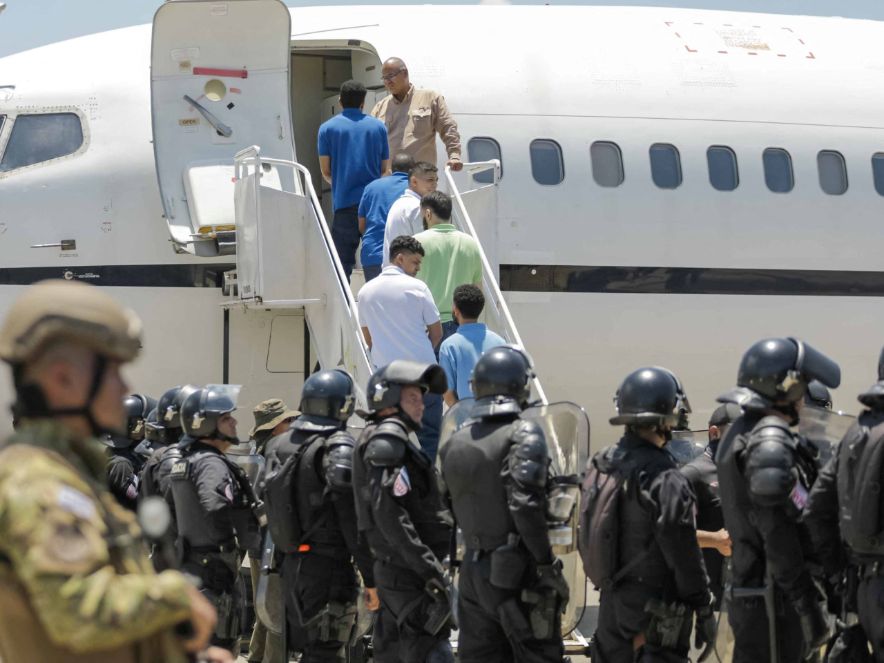 Venezuelan detainees board a plane for home as part of an exchange deal with the United States. Photo: Reuters