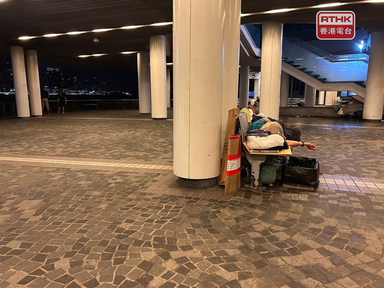 有露宿者在長櫈上睡覺。（林漢山攝）