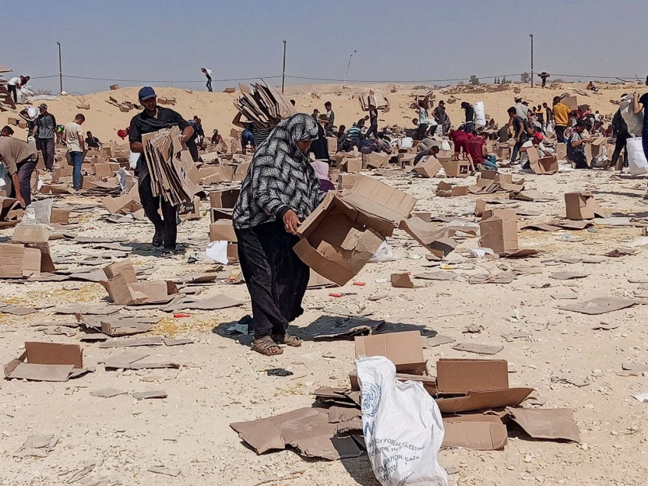 Palestinians collect what remains of relief supplies from an aid distribution centre of the US-backed Gaza Humanitarian Foundation. Photo: Reuters