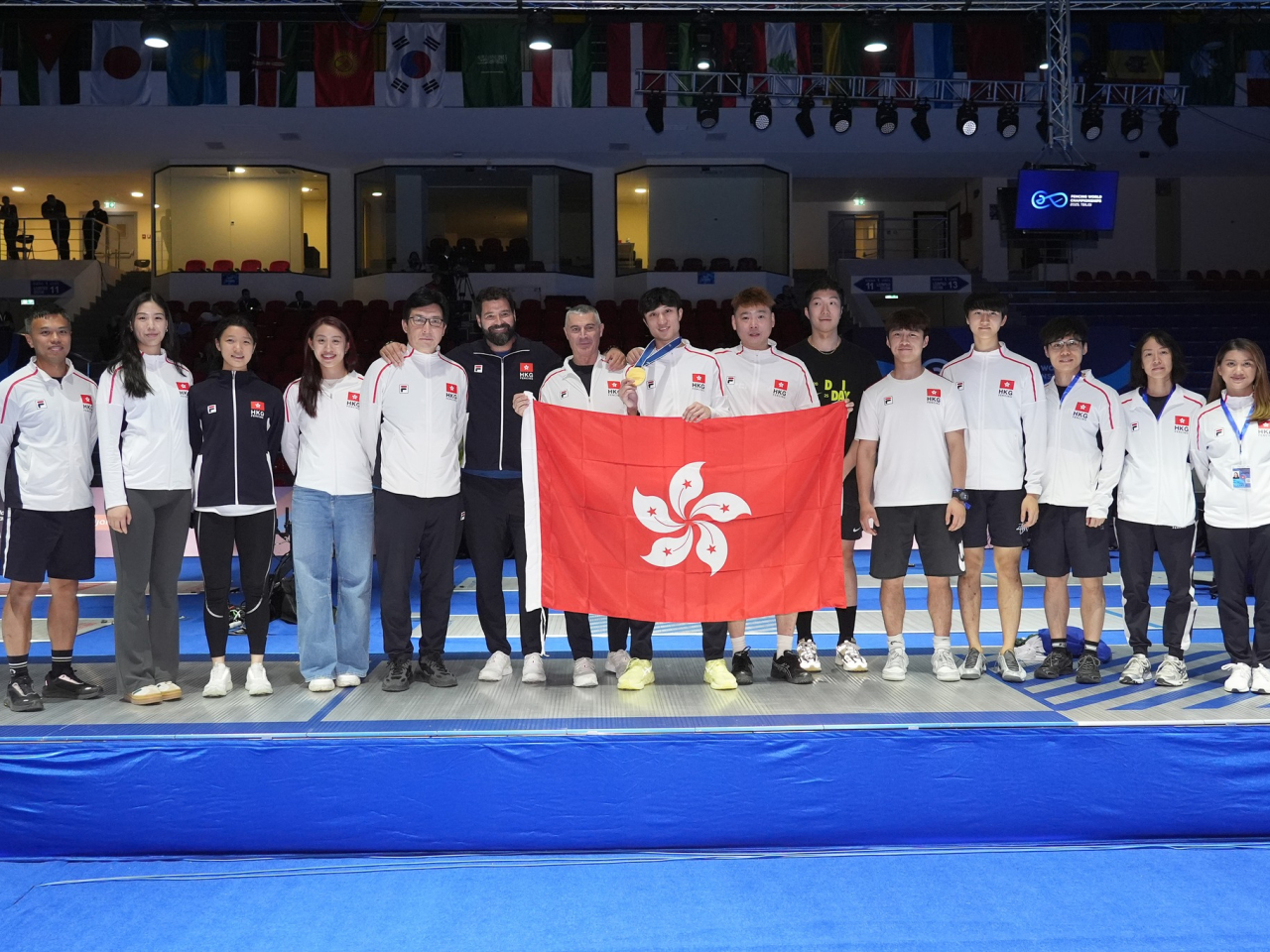 The SAR team celebrates following Choi's historic gold. Photo courtesy of the International Fencing Federation