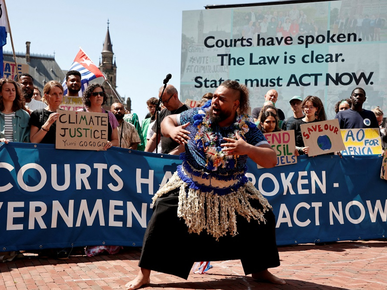 Climate activists and campaigners demonstrate outside the International Court of Justice ahead of the reading of the advisory opinion. Photo: Reuters