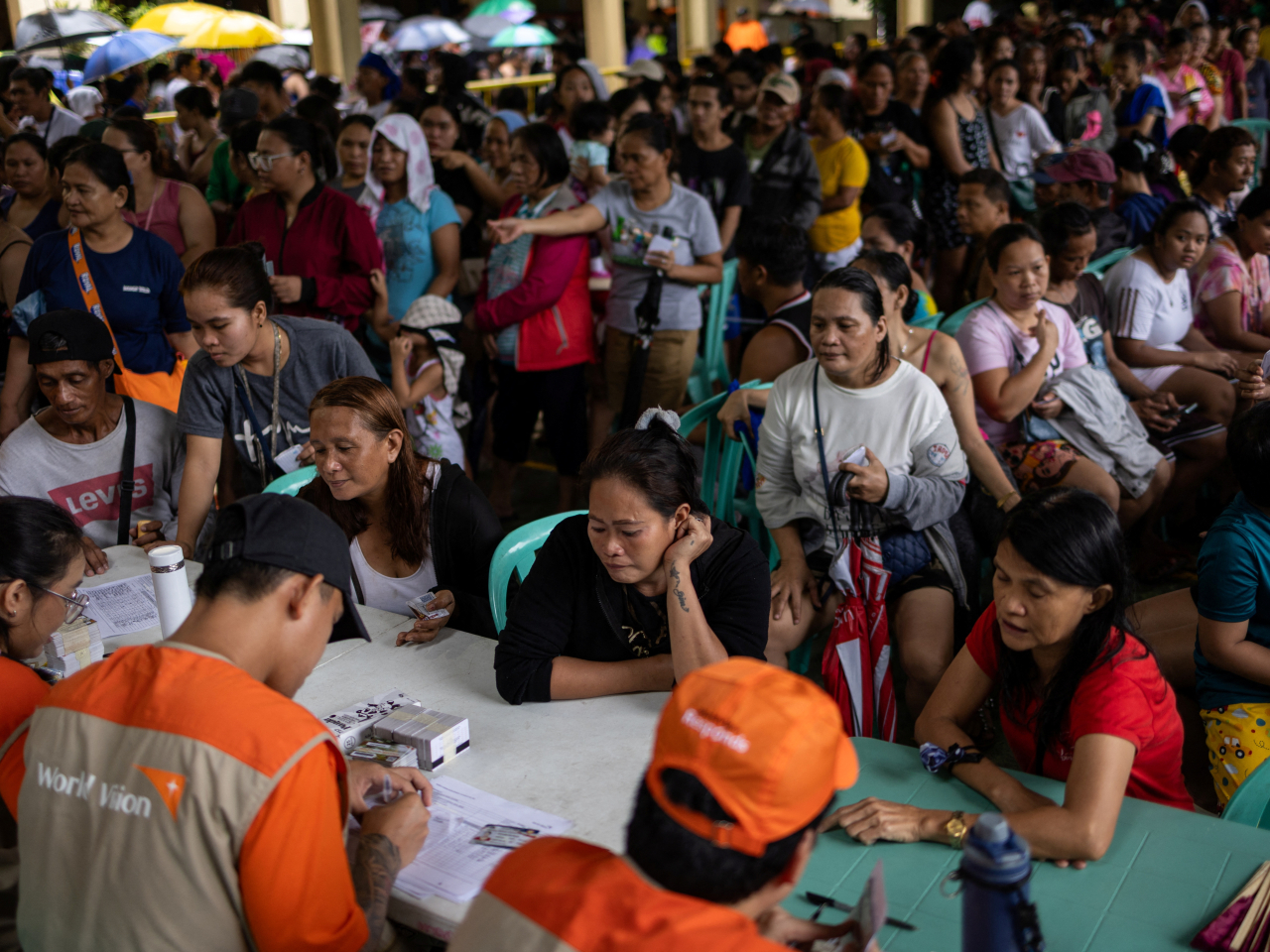 Residents queue for relief at a school-turned-evacuation center in Quezon City. Photo: Reuters