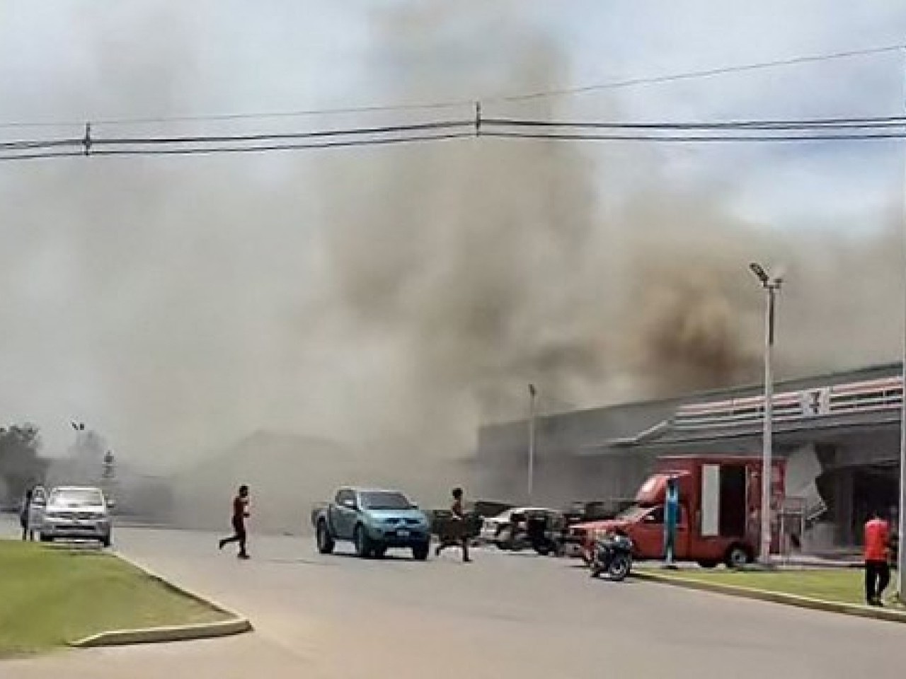 Smoke billows from a convenience store in Sisaket province in Thailand after it is hit by a rocket strike from Cambodia. Photo: Facebook user Chatchak Ratsamikaeo via AFP