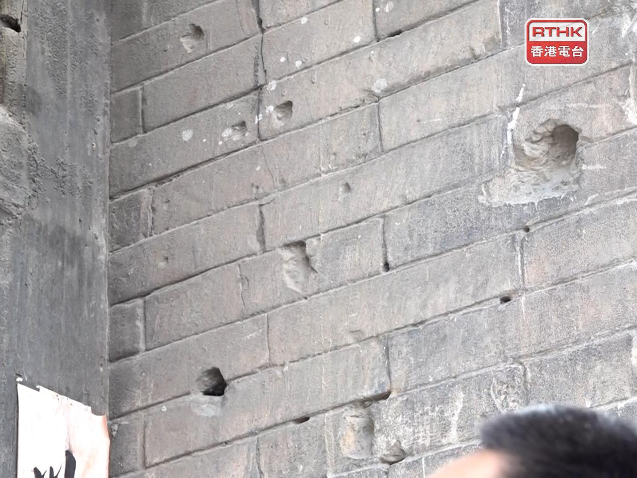 Deep bullet holes still scar the walls of the historic buildings. Photo: RTHK