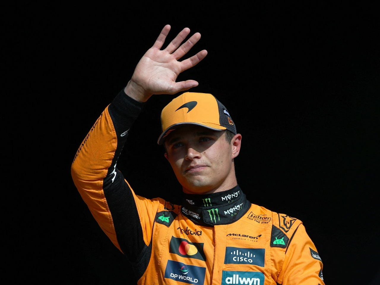 Norris acknowledges the crowd after securing his 13th career pole. Photo: Reuters