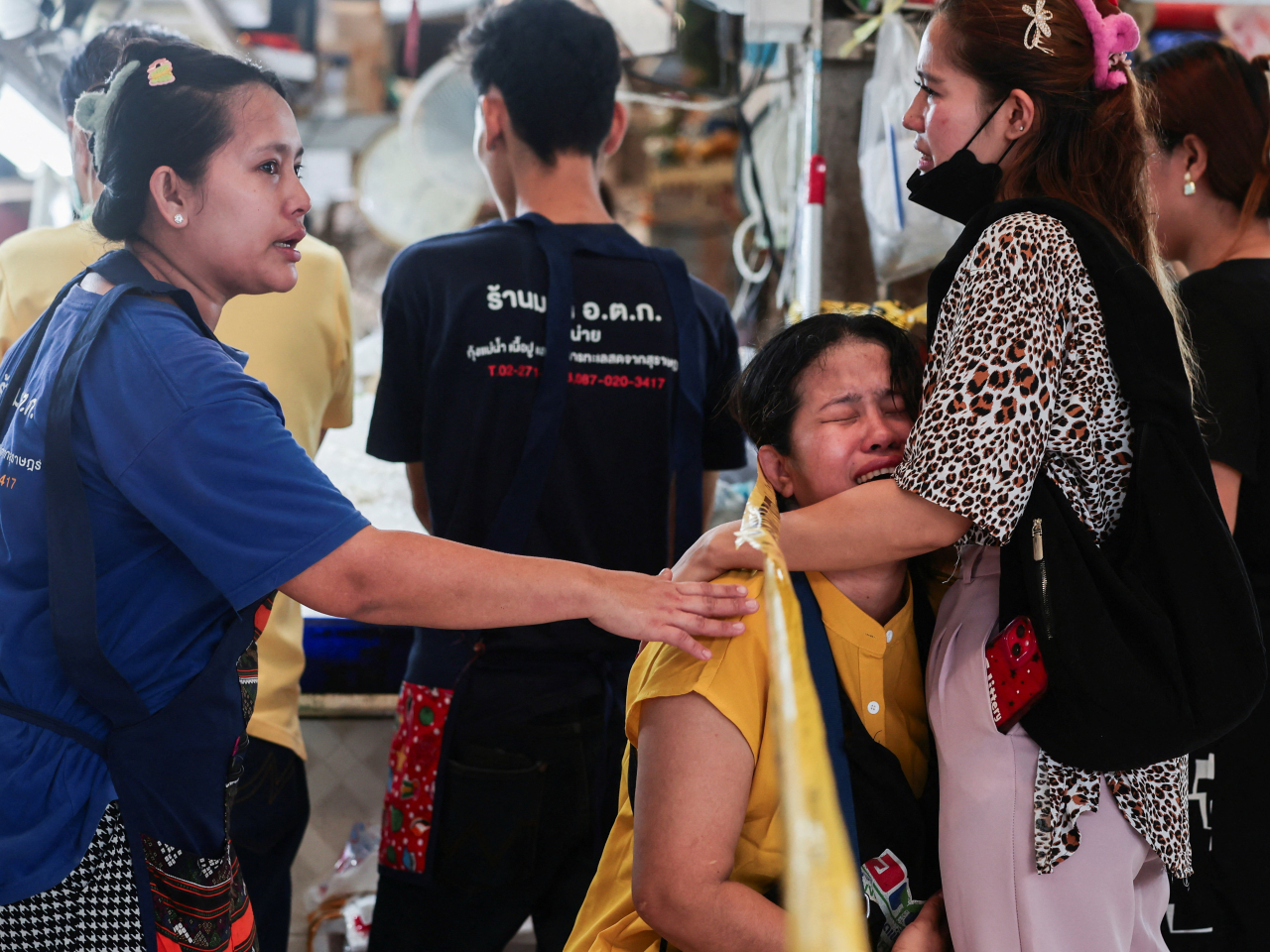 People mourn those killed in the market shootings in Bangkok. Photo: Reuters