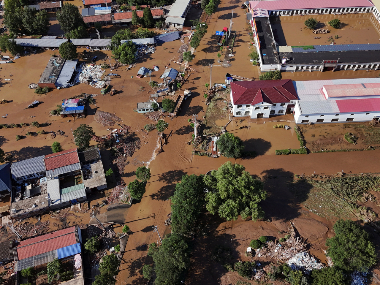 A bird's eye view shows partially submerged village houses and other buildings after heavy rainfall flooded an area in Miyun district in Beijing. Photo: Reuters