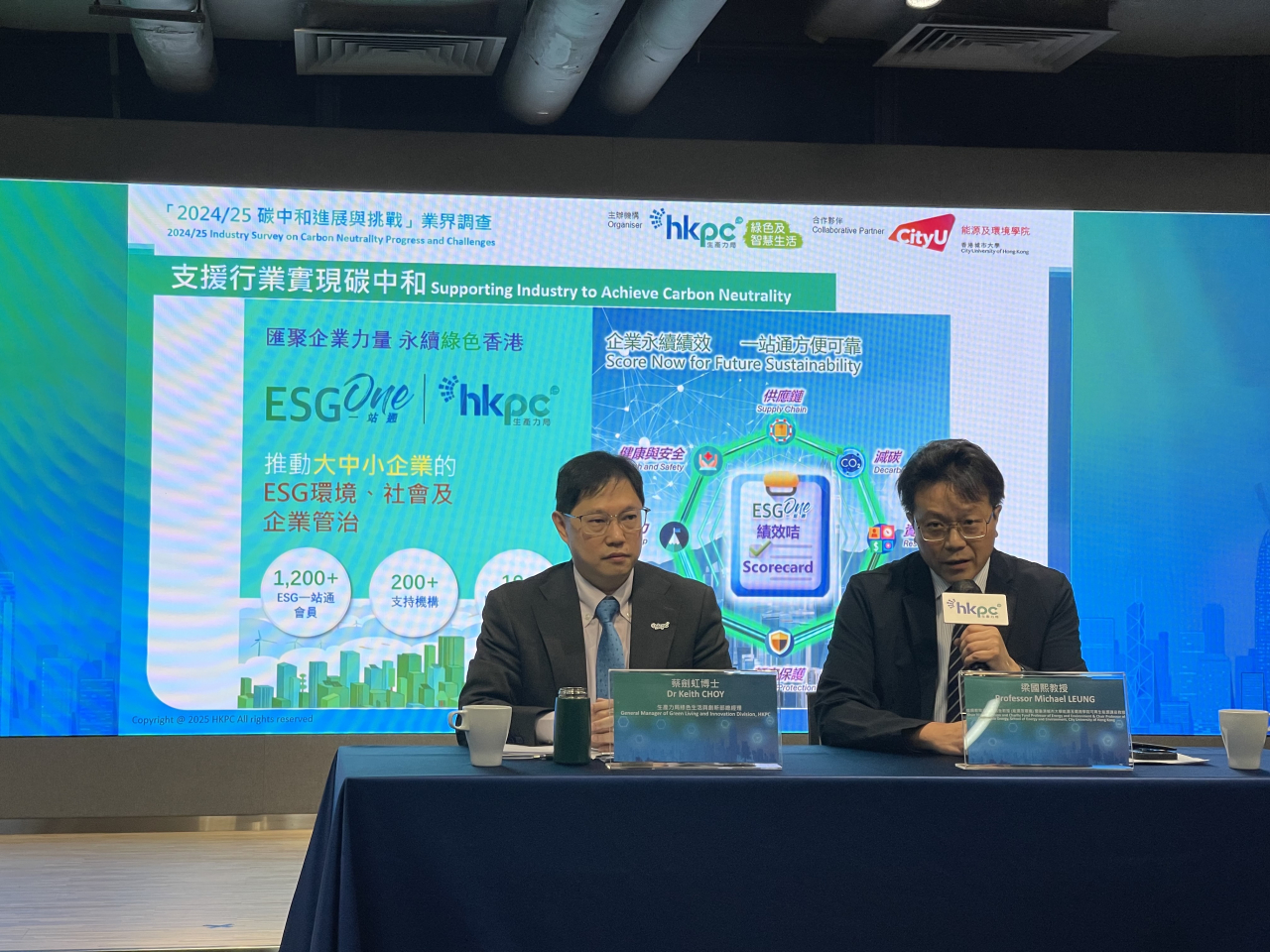 The Productivity Council's Keith Choy looks on as his City University counterpart announces a survey finding. Photo: RTHK
