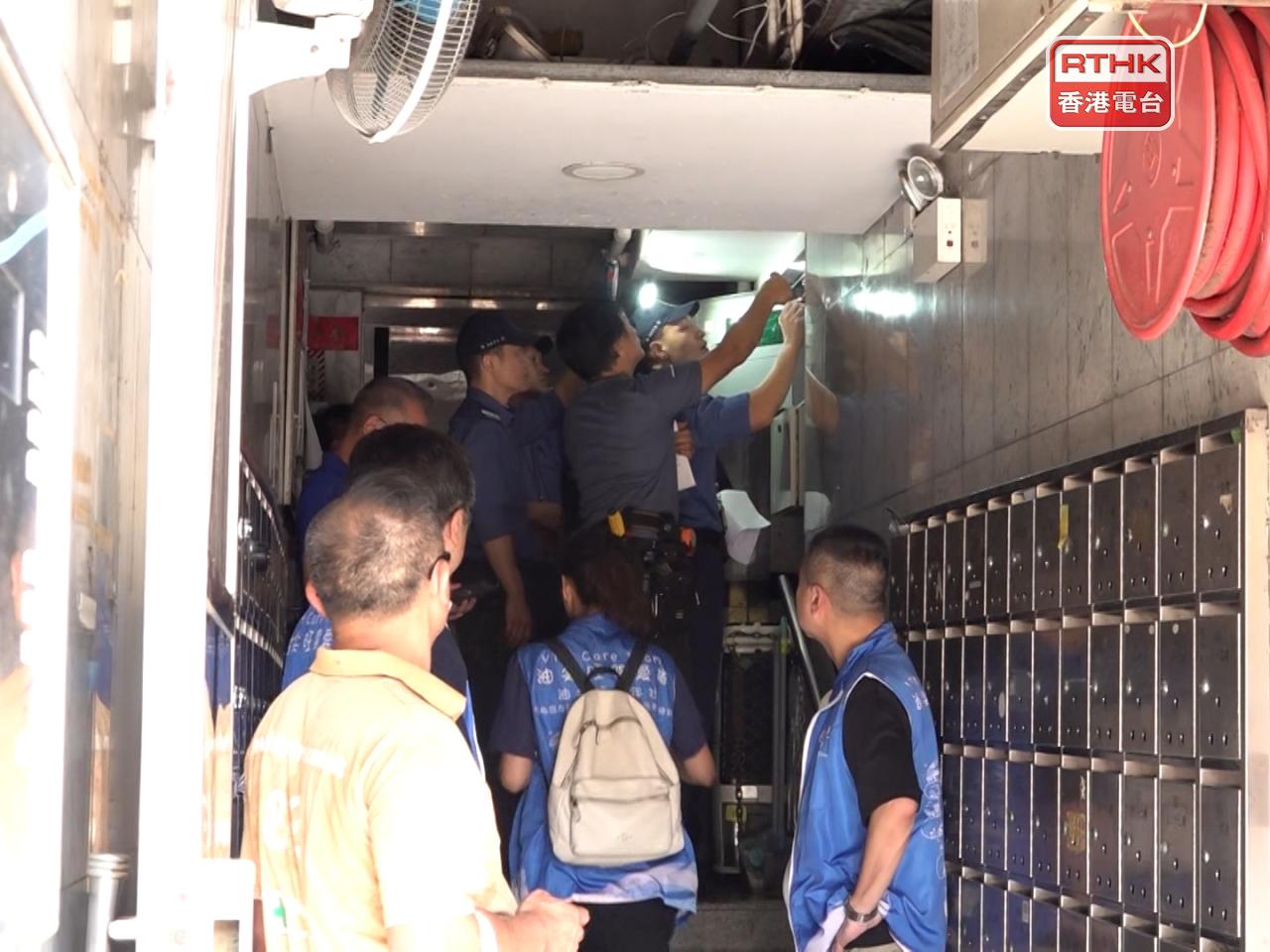Firefighters and government laboratory personnel conduct checks at Kin Wong Mansion on Friday. Photo: RTHK