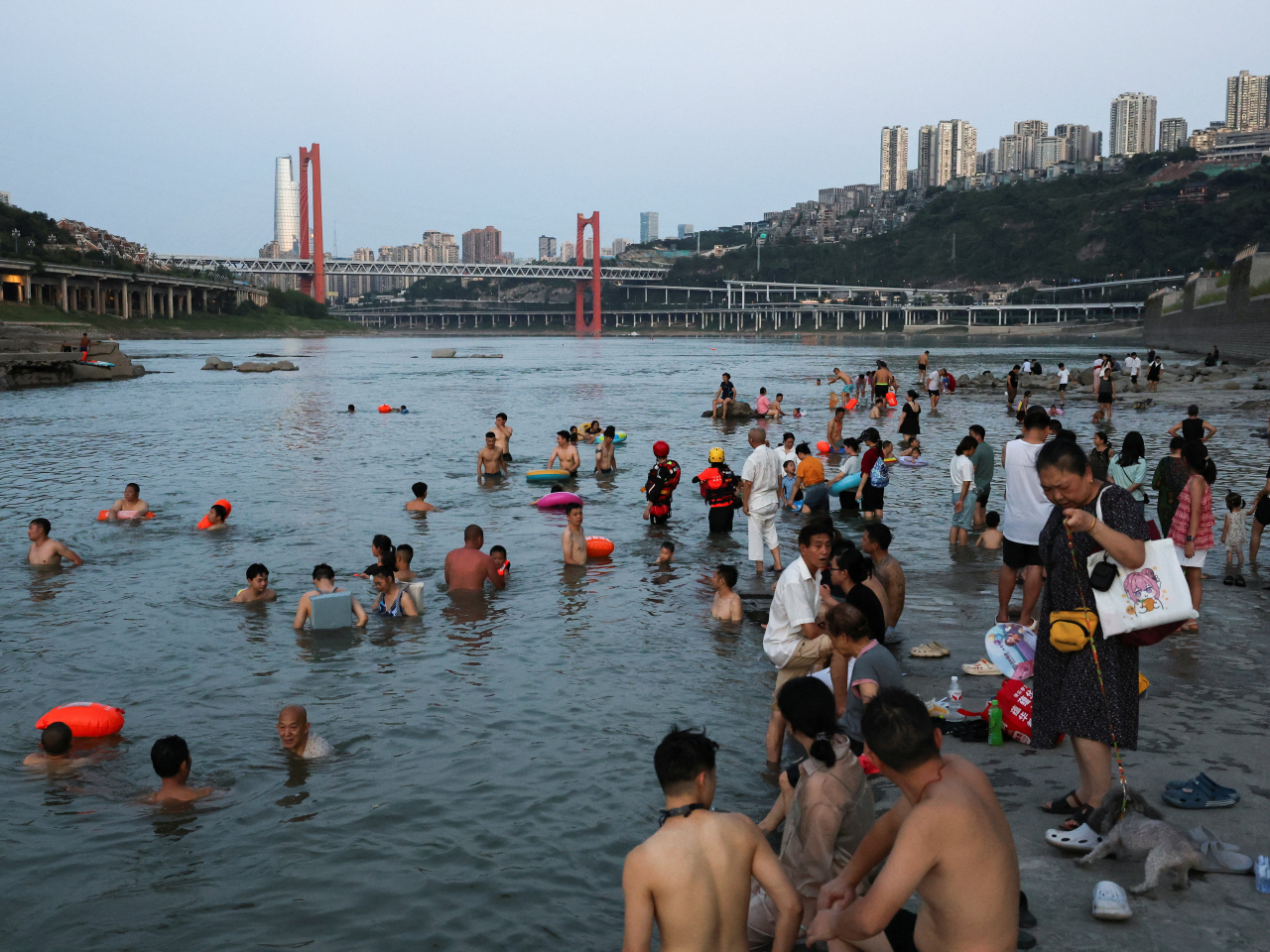 People soak in the Jialing River to escape the scorching heat. Photo: Reuters
