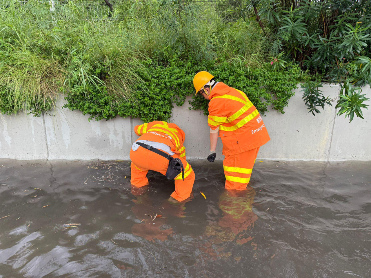 Emergency personnel attend to serious flooding on the North Lantau Highway. Photo courtesy of the Drainage Services Department