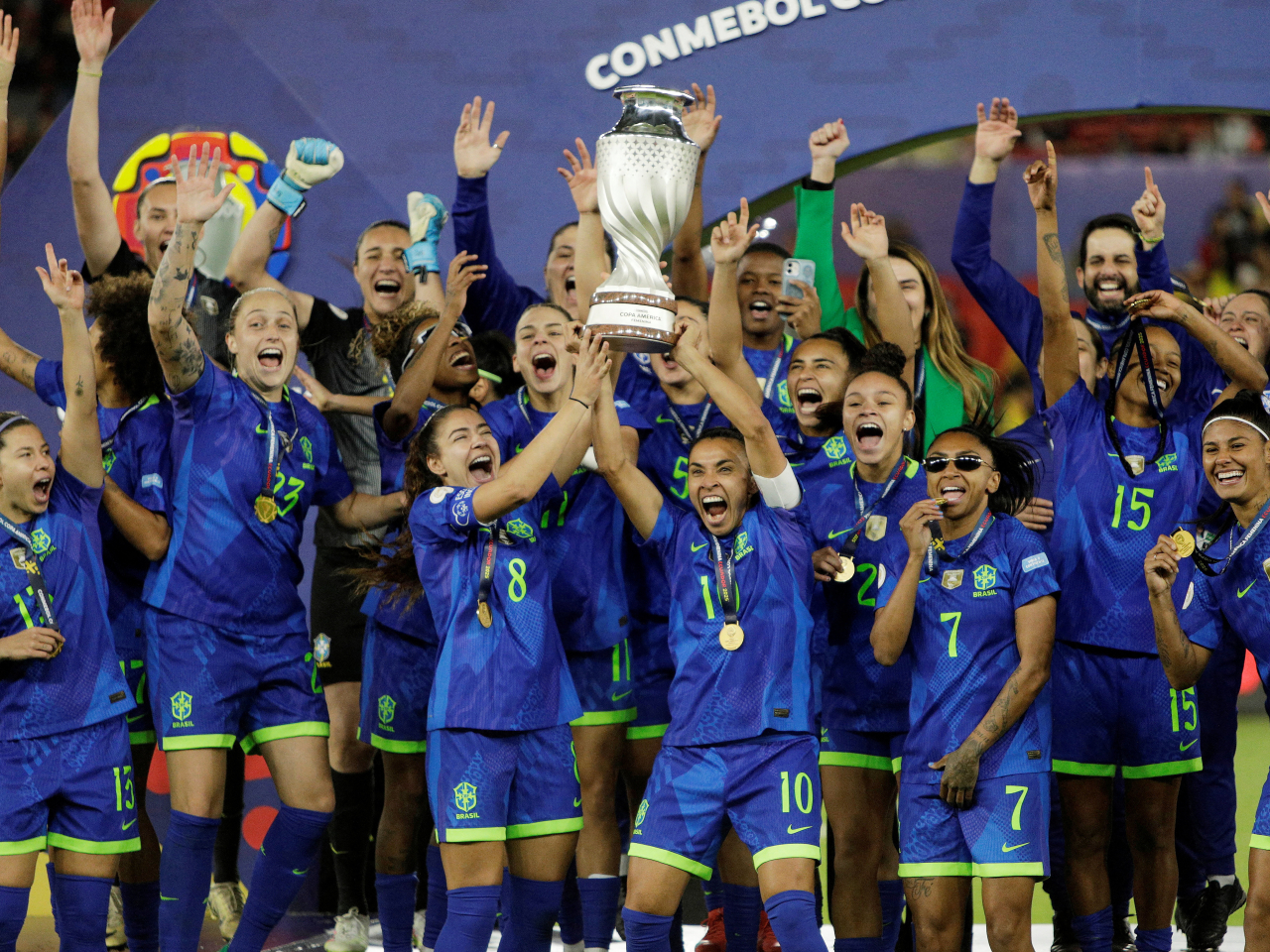 Marta and Angelina lift the trophy as they celebrate with teammates after winning the Women's Copa America. Photo: Reuters