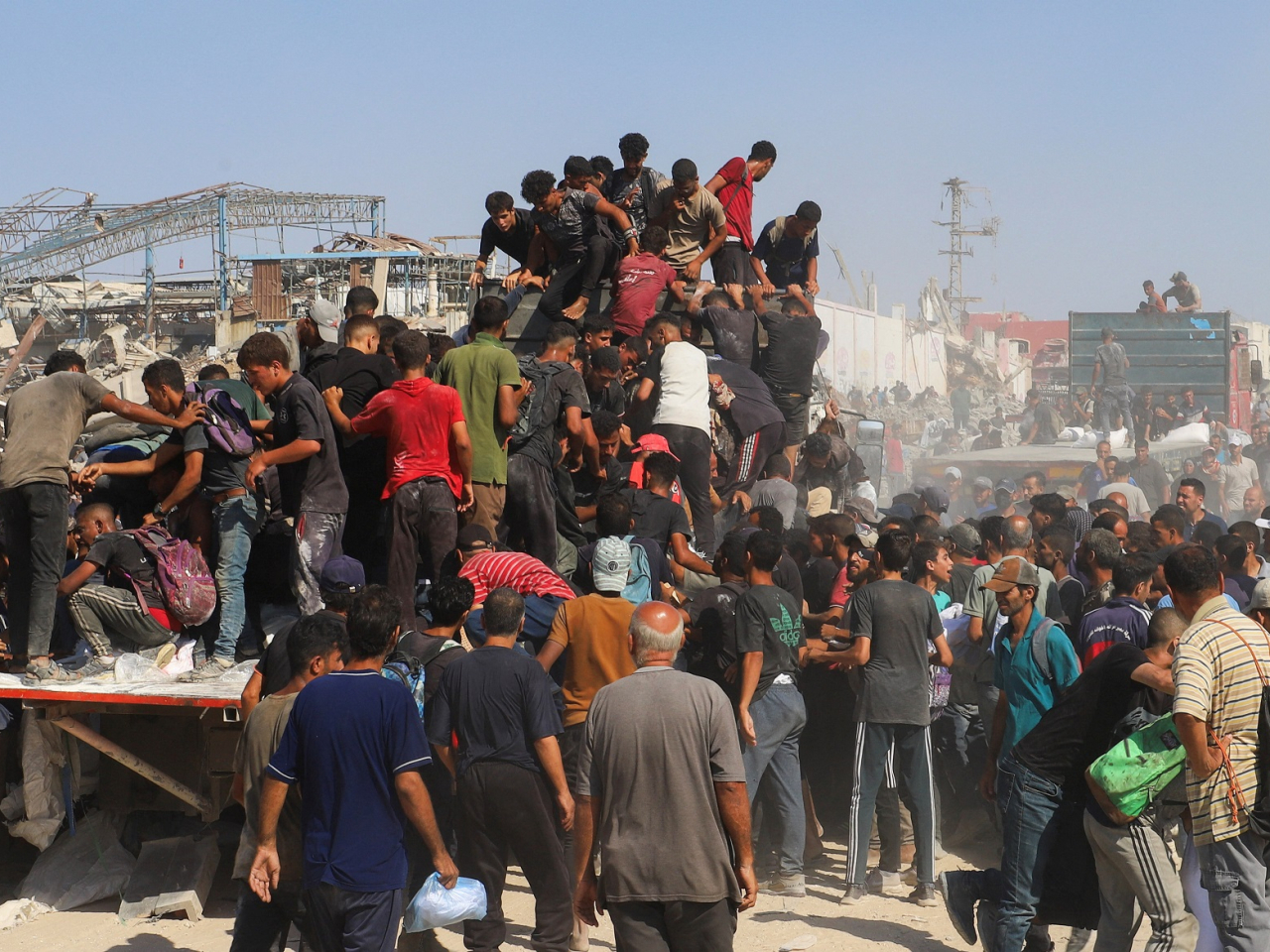 Palestinians ride on the back of a truck, after aid supplies that entered Gaza through Israel were distributed in the northern Gaza Strip. Photo: Reuters