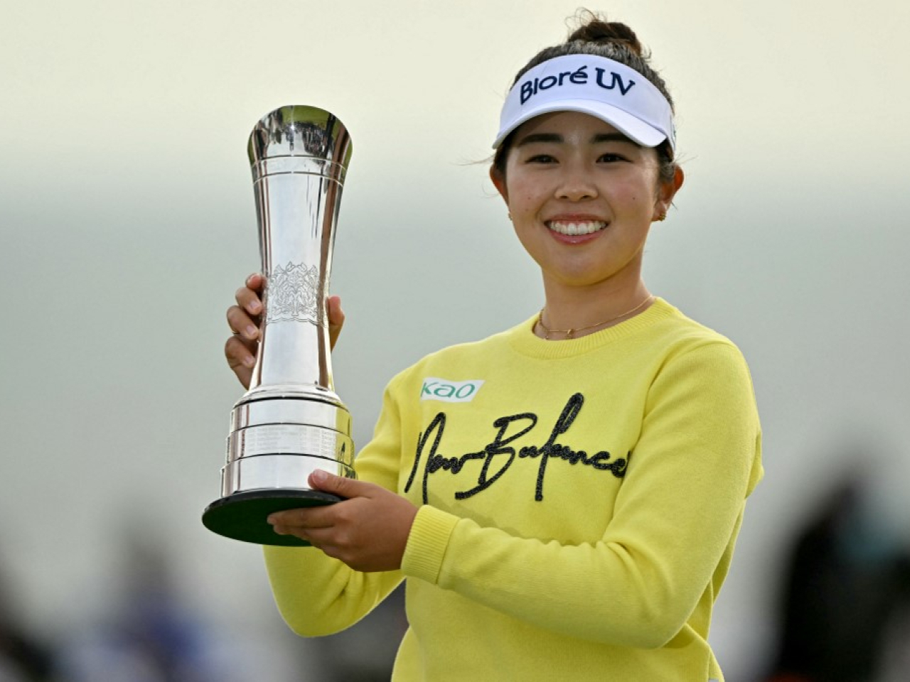 Miyu Yamashita lifts the trophy after winning on the final day of the Women's British Open Golf Championship. Photo: AFP