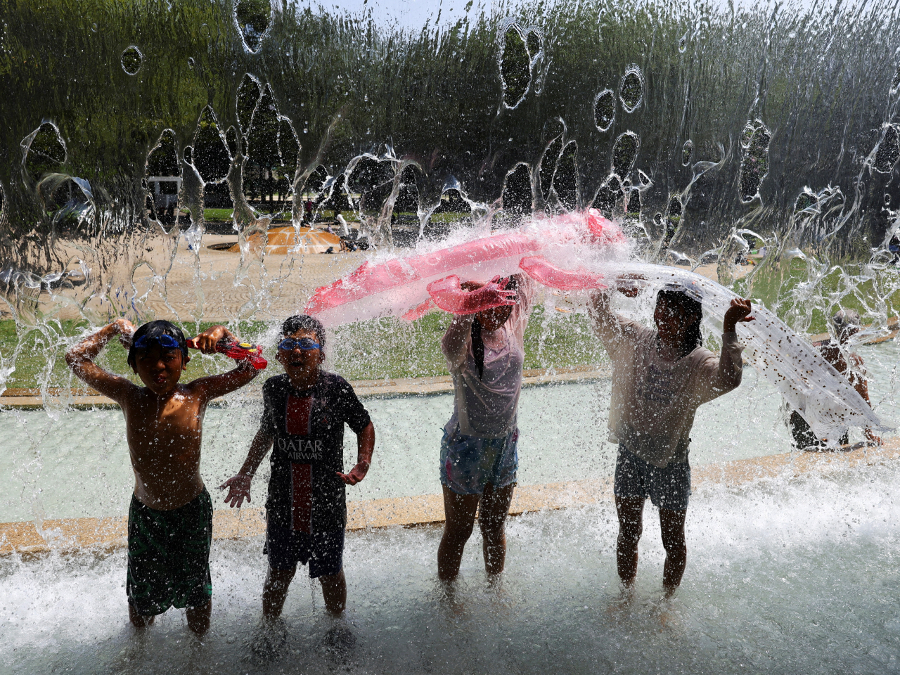 Children cool off in a Tokyo park amid a heatstroke alert in the capital and other prefectures. Photo: Reuters