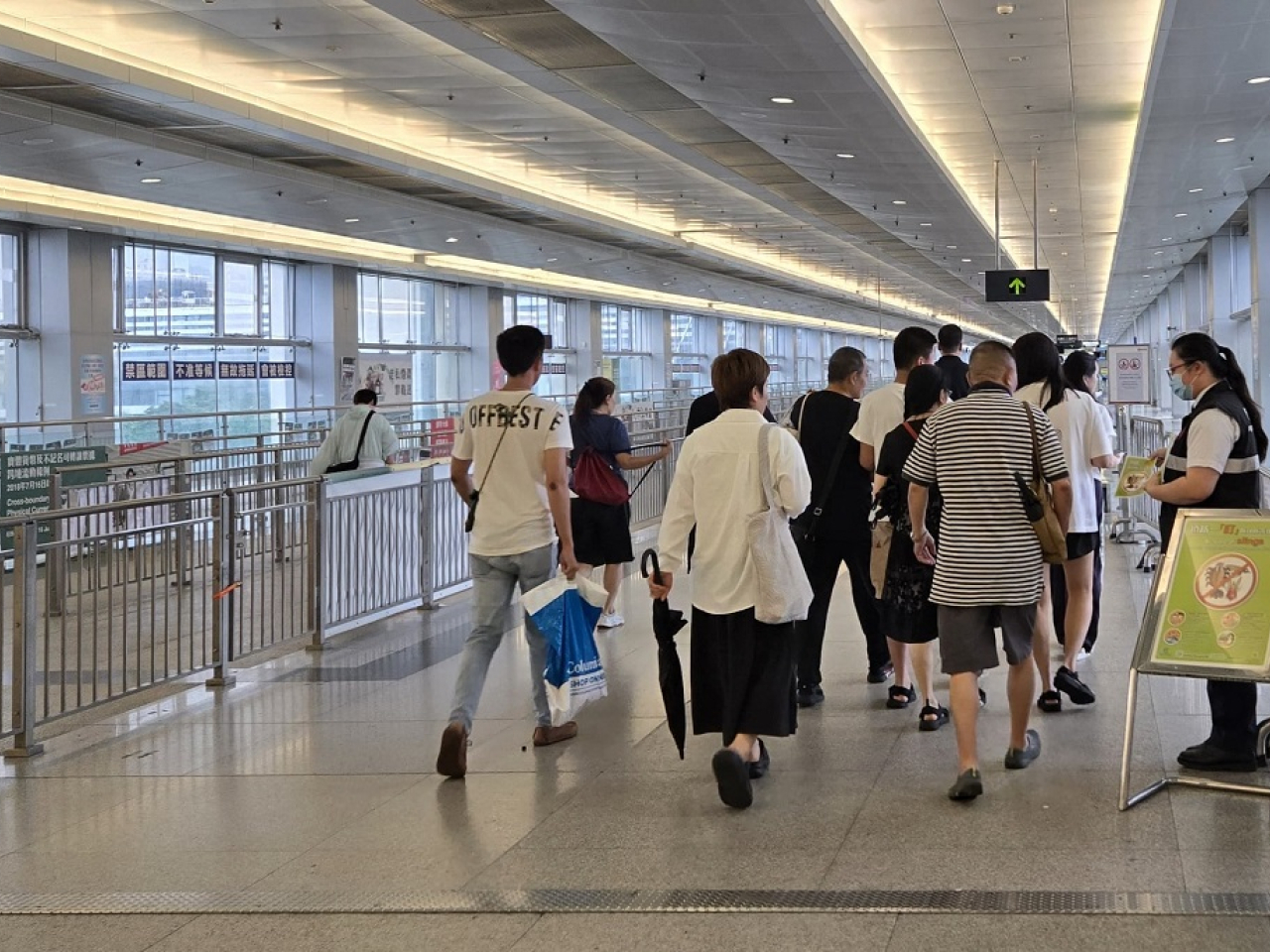港口衞生科人員在落馬洲支線出入境管制站向旅客派發單張，加強有關基孔肯雅熱的宣傳教育工作。（政府新聞處）