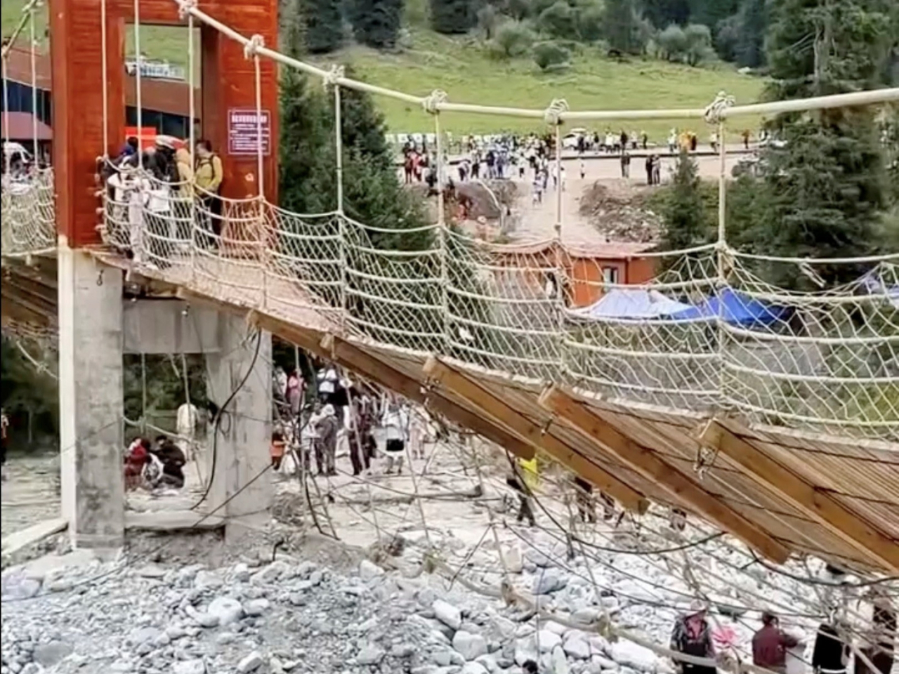 The 29 people fell when one of the bridge's suspension cable snapped, causing the walkway to tilt. Online photo via Reuters