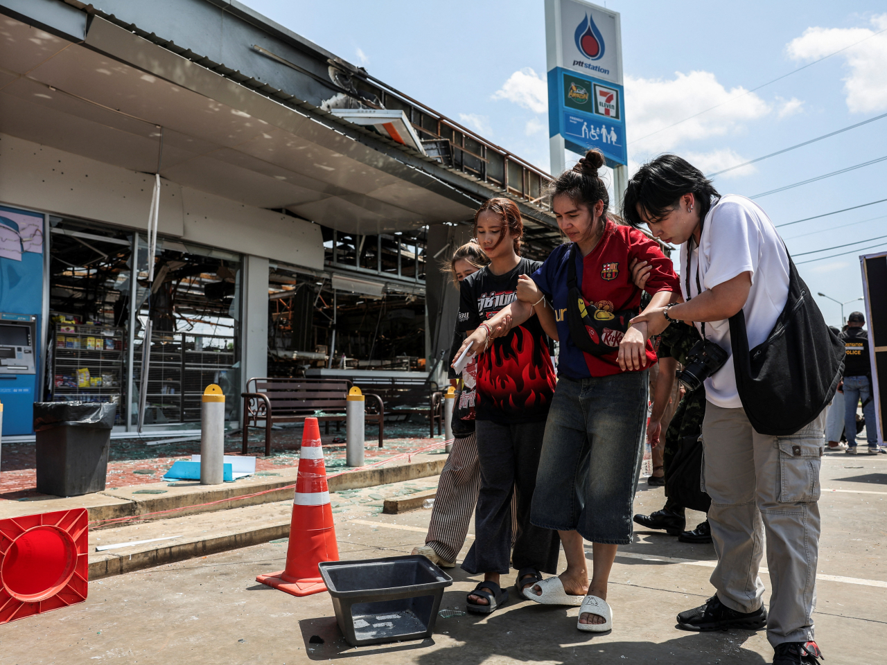 A Thai injured by shelling that hit a convenience store and gas station in Sisaket province gets a hand after meeting foreign observers near the border with Cambodia early in August. File photo: Reuters
