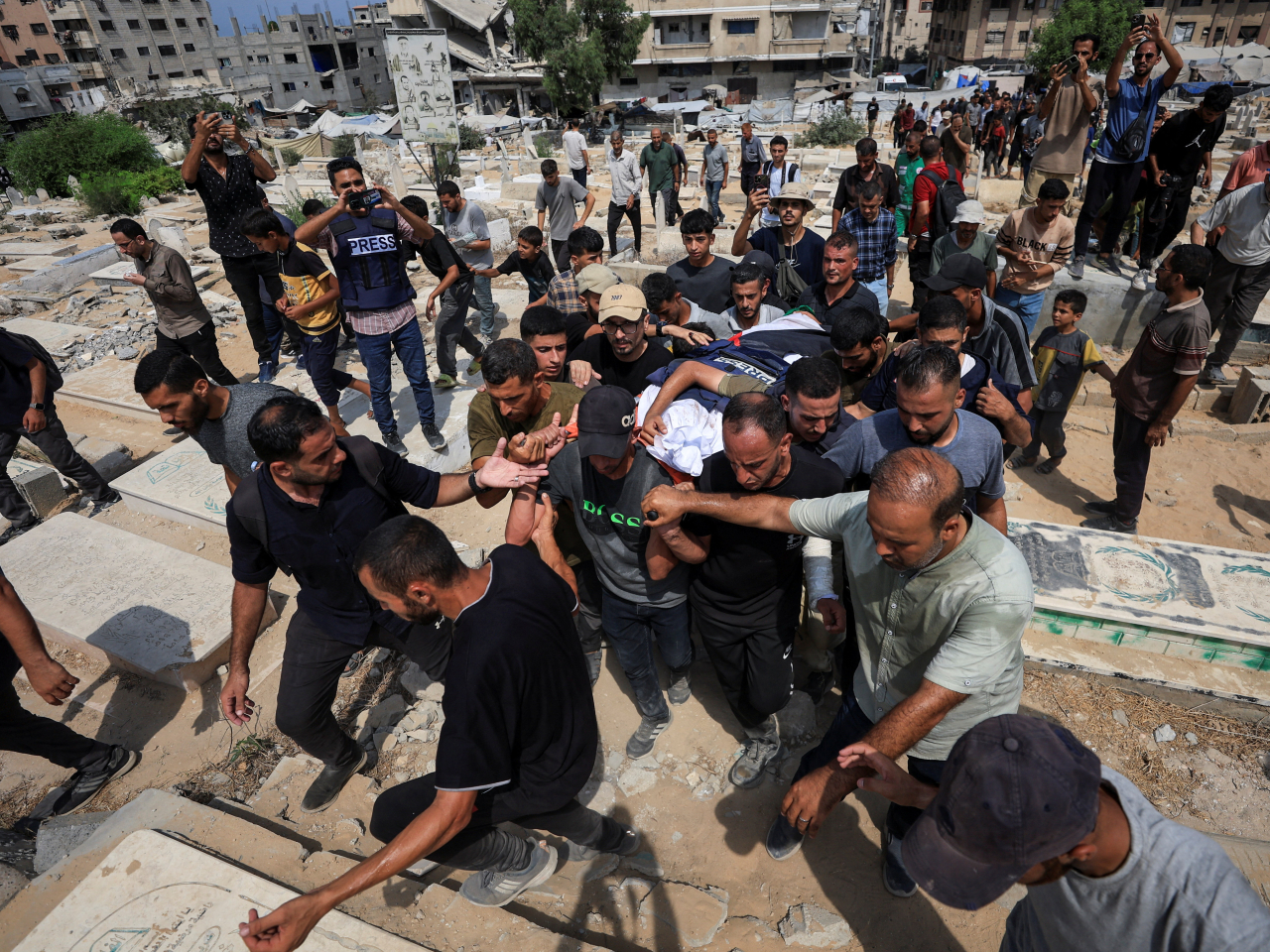 Mourners attend the funeral in Gaza City of the five Al Jazeera journalists killed in an Israeli strike. Photo: Reuters