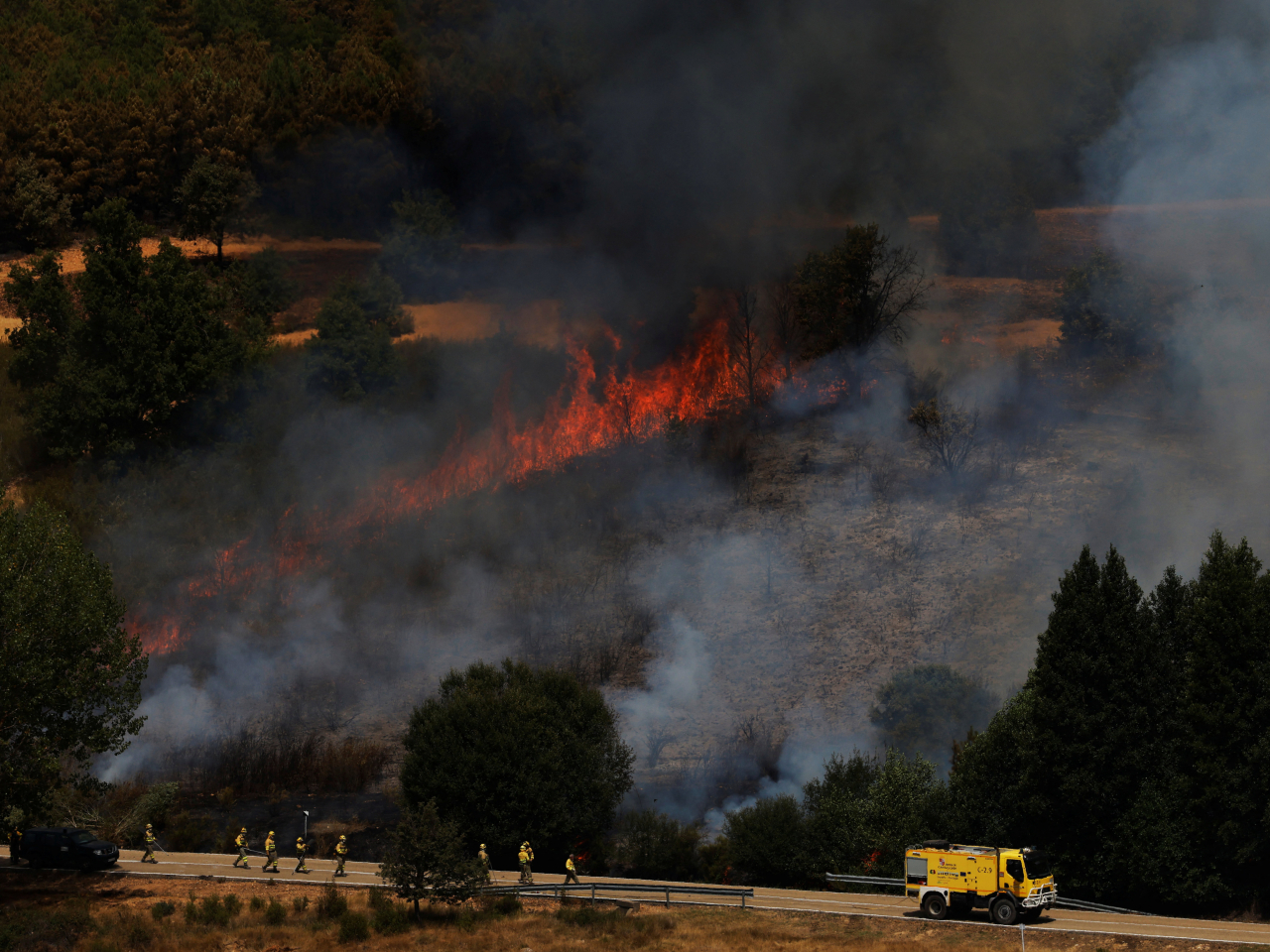 Firefighters try to contain a wildfire outside Congosta, northern Spain. Photo: Reuters