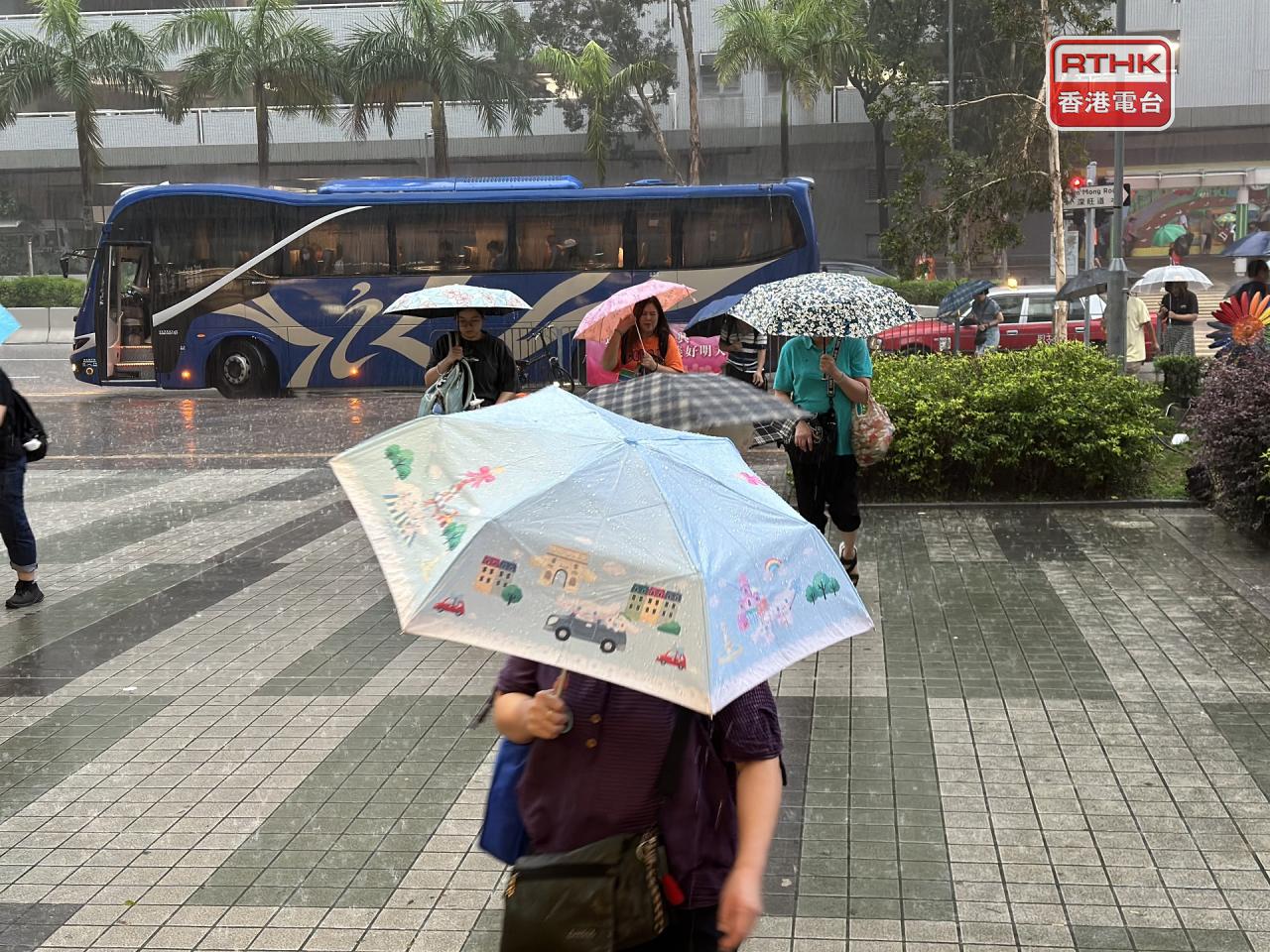 Some commuters were on their way to work by the time the Black Rainstorm Warning Signal was issued. Photo: RTHK