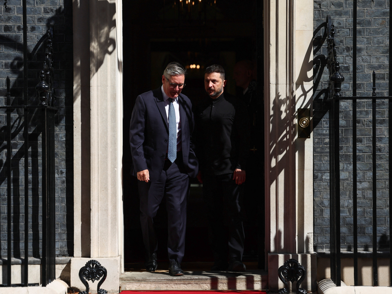 Ukrainian President Volodymyr Zelenskiy, right, and British Prime Minister Keir Starmer depart 10 Downing Street, in London. Photo: Reuters