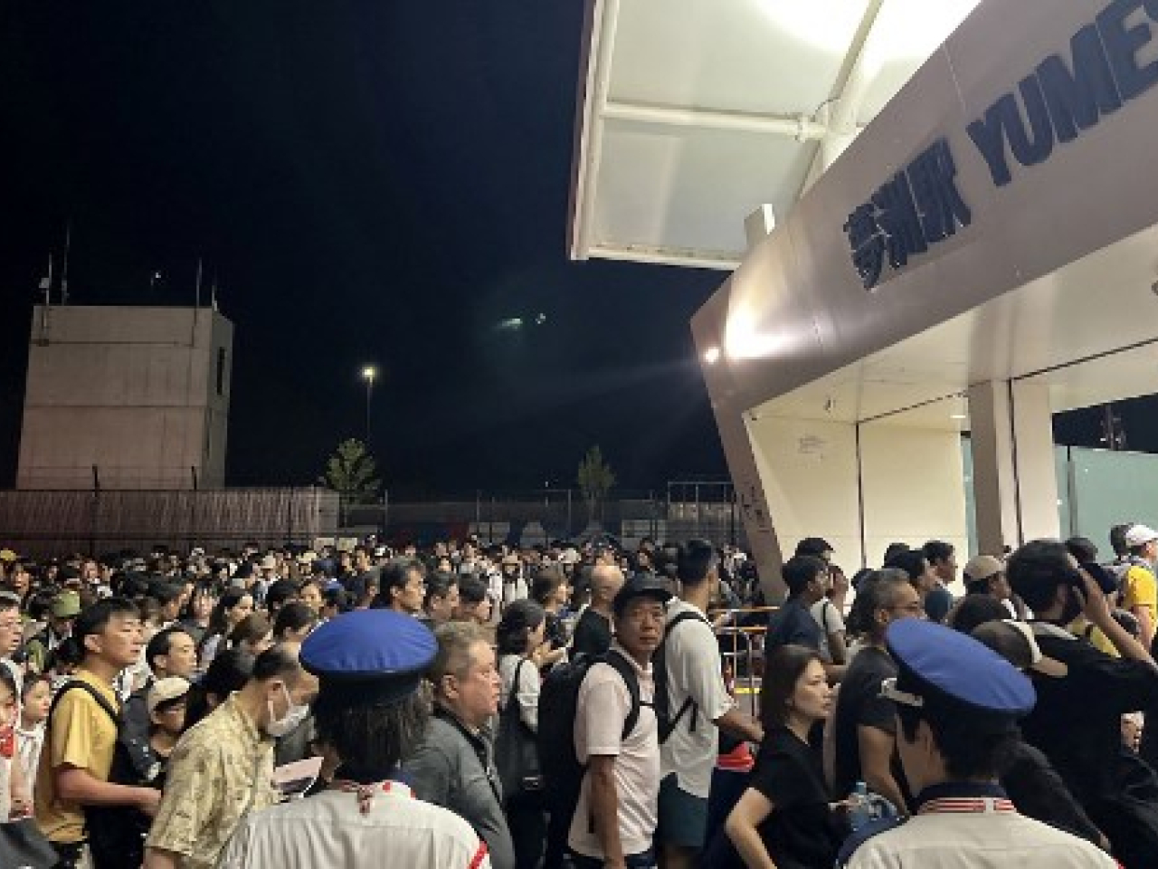 Visitors crowd in front of the entrance to Osaka Metro Yumeshima Station after a power outage abruptly shut down the line. Photo: JIJI Press via AFP