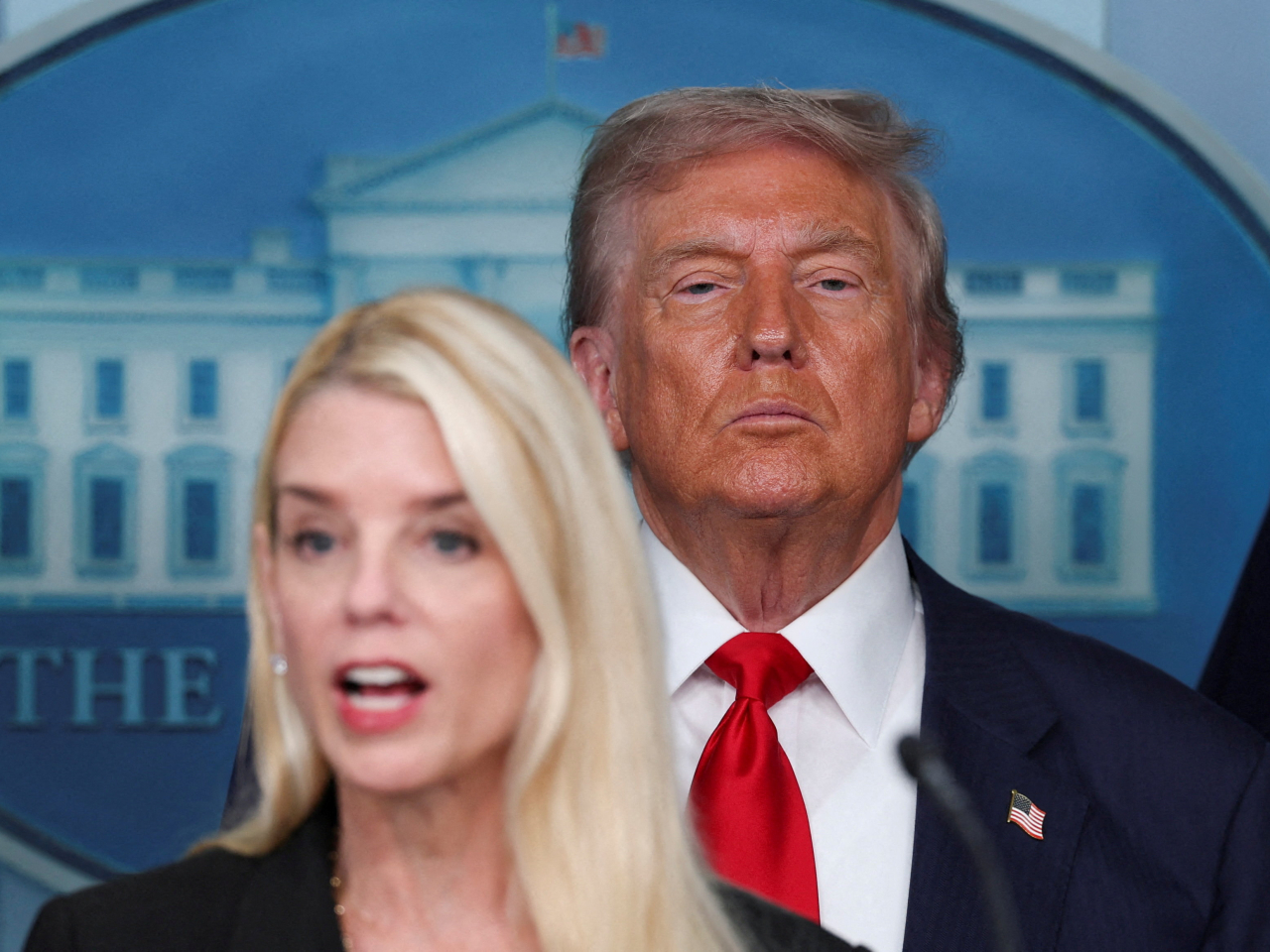 Pam Bondi, with Donald Trump looking on, says Washington police must receive approval from the new 'emergency police commissioner'. File photo: Reuters