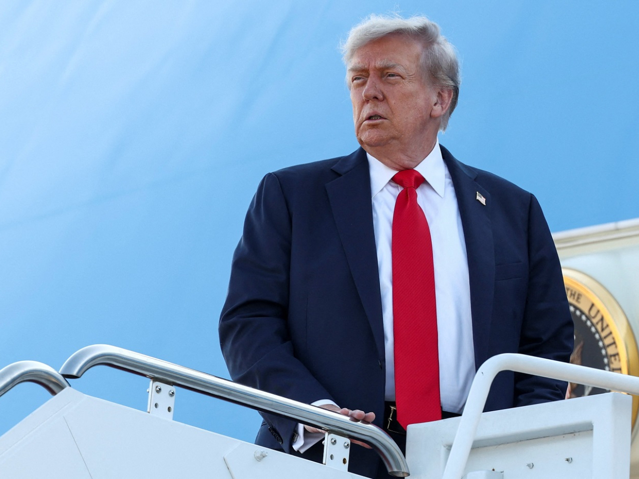 Donald Trump boards Air Force One as he departs for Alaska to meet with Vladimir Putin. Photo: Reuters