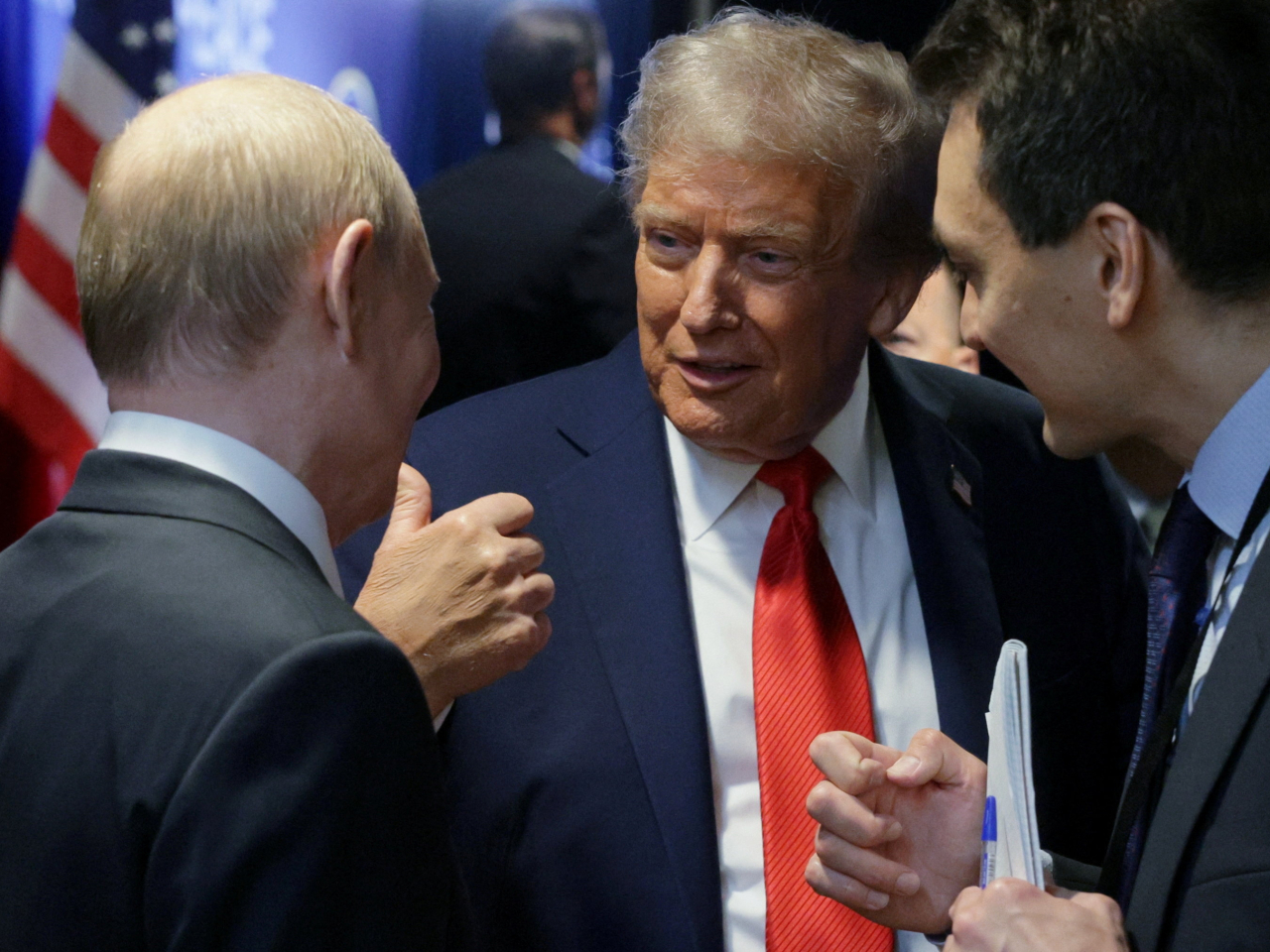 US President Donald Trump talks with Russian President Vladimir Putin after their post-summit press conference. Photo: Reuters