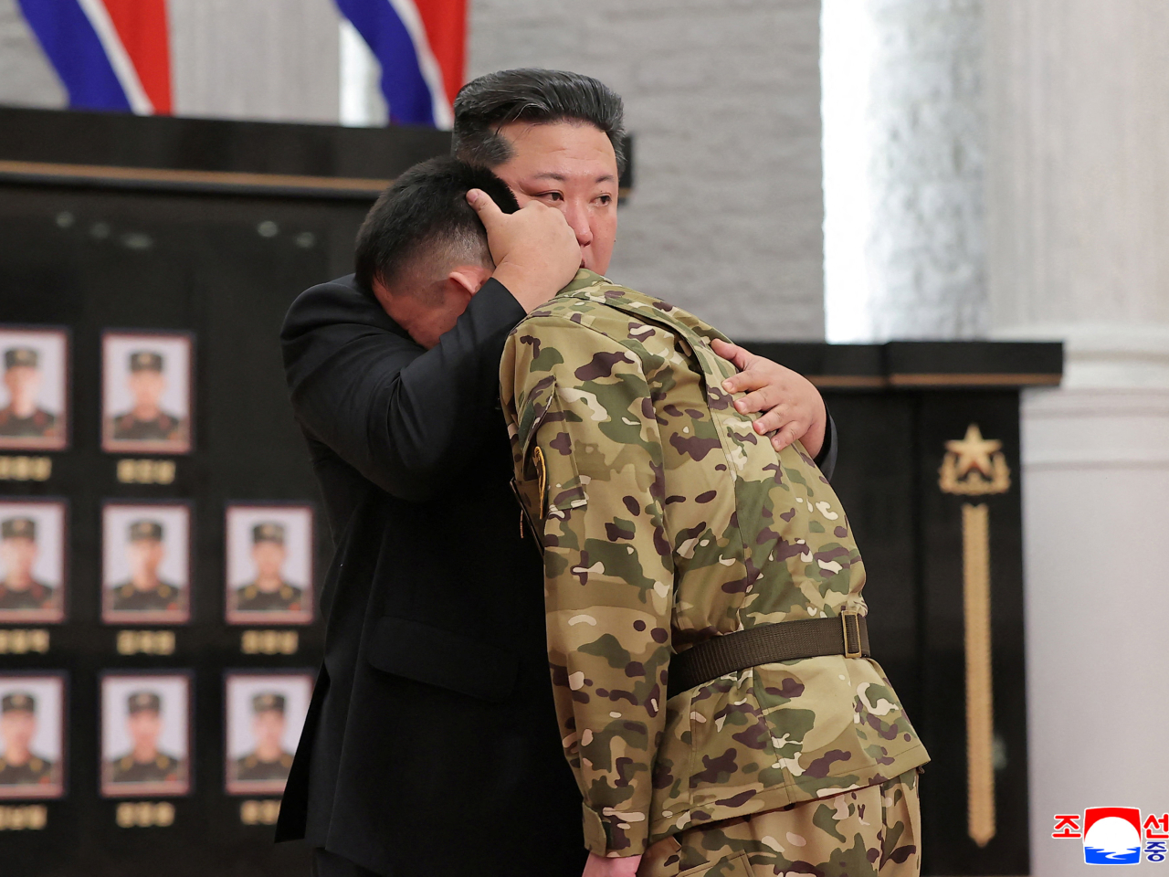 Kim Jong Un consoles a soldier at the ceremony for North Korean troops who had fought against Ukraine in Russia's Kursk region. Photo: Reuters