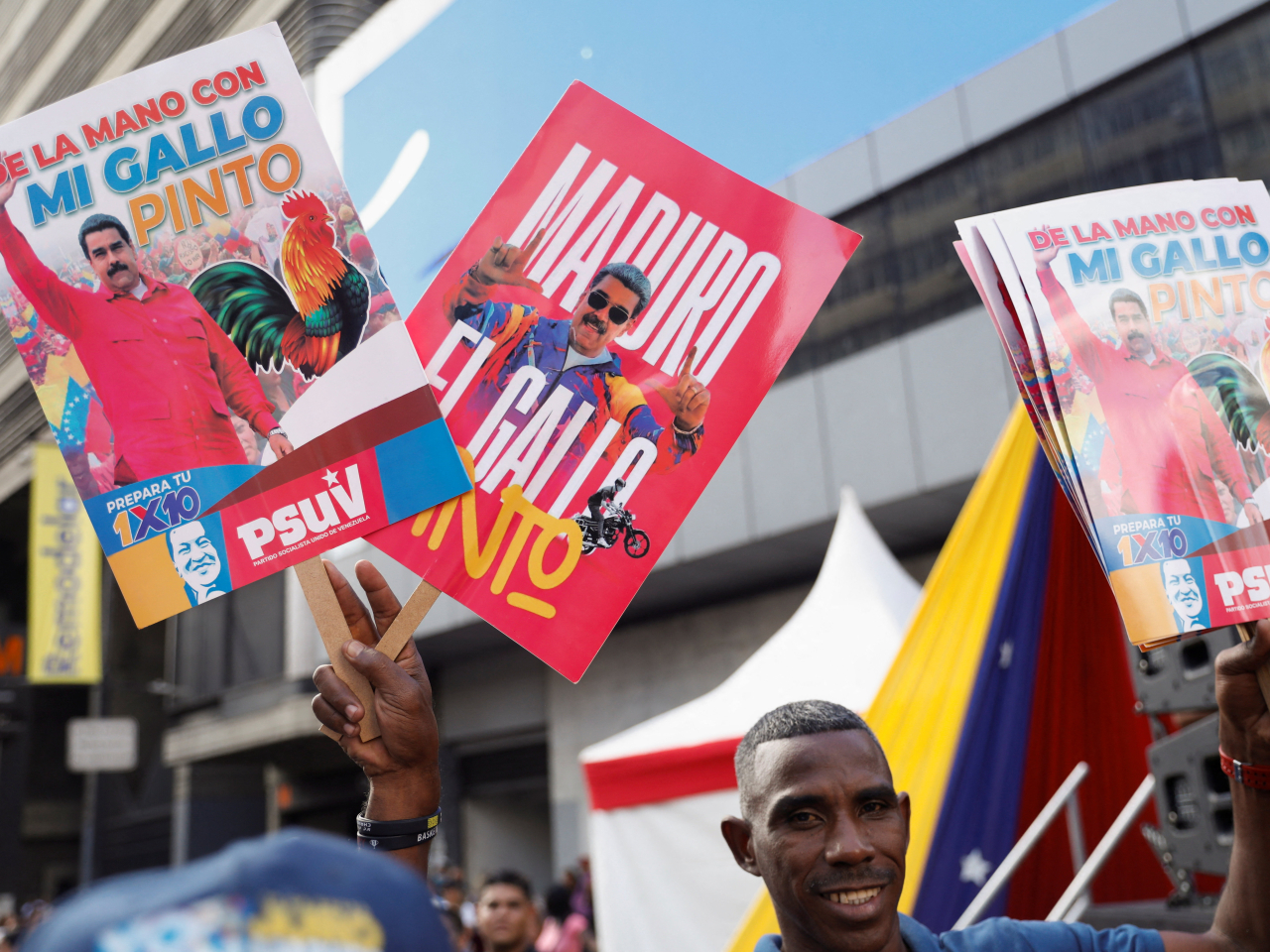 A Venezuelan government supporter waves placards bearing images of President Nicolas Maduro in Caracas. File photo: Reuters
