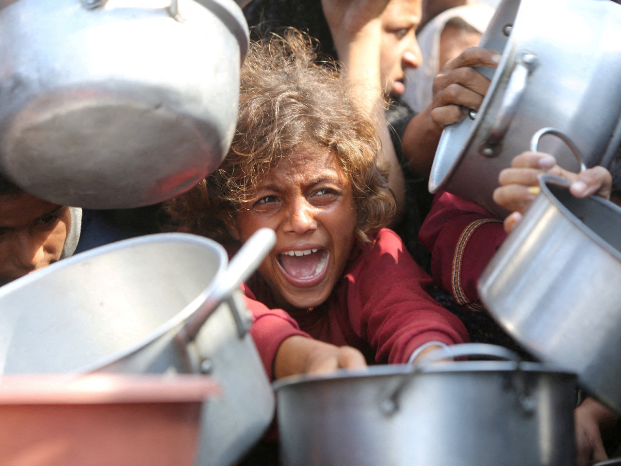 Palestinians wait to receive food from a charity kitchen in Khan Younis. File photo: Reuters