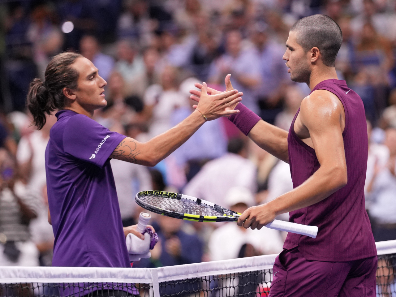 Carlos Alcaraz greets Mattia Bellucci after beating him in just over 90 minutes to advance into the next round at Flushing Meadows. Photo: Reuters