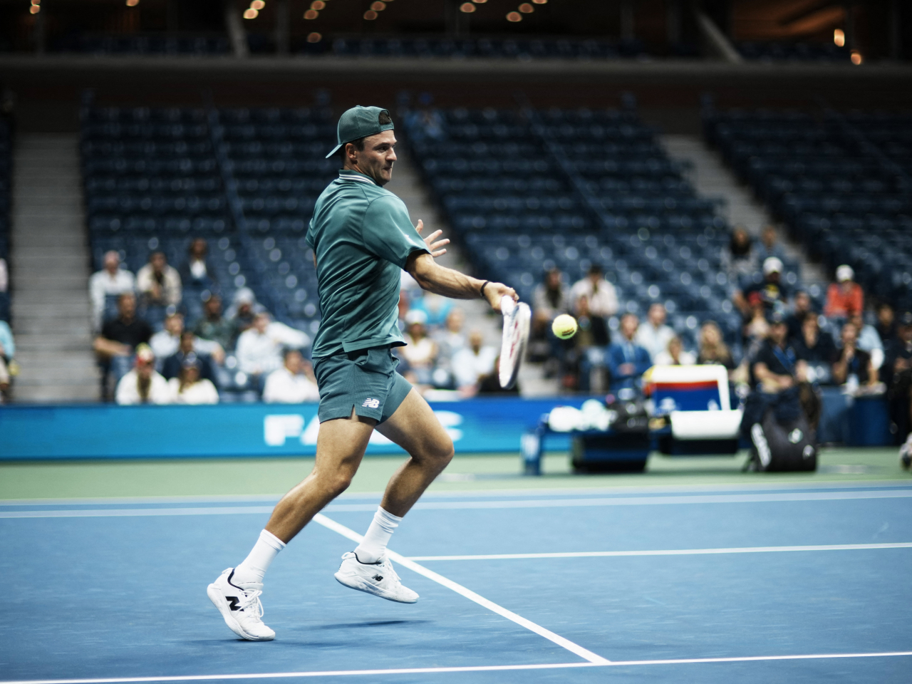 Tommy Paul goes for a return shot before a sparse home crowd as his match against Nuno Borges goes into the wee hours. Photo: Reuters