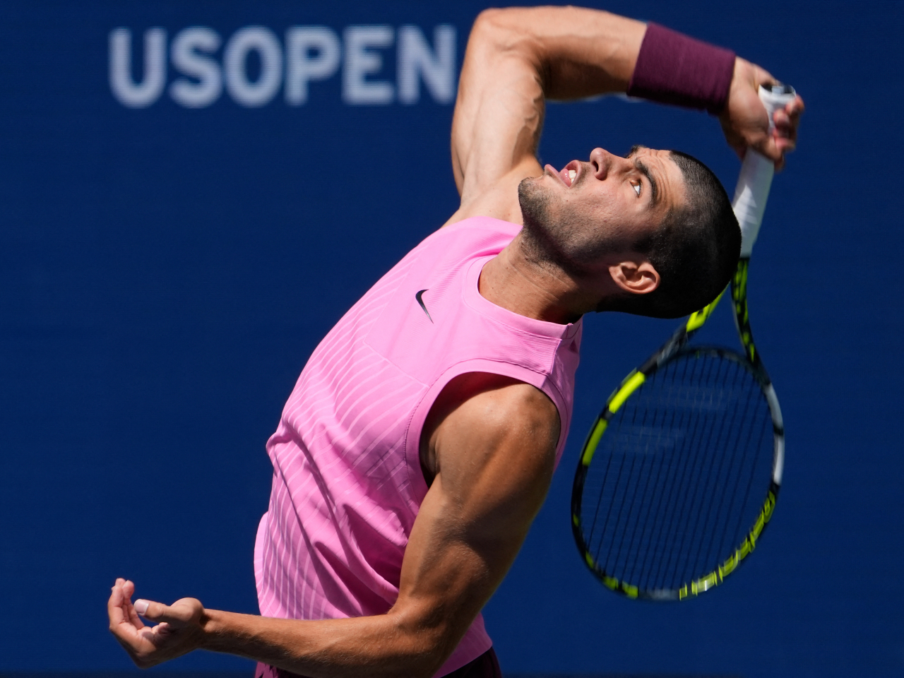 Carlos Alcaraz goes up for a serve against Italy's Luciano Darderi at Flushing Meadows. Photo: Reuters