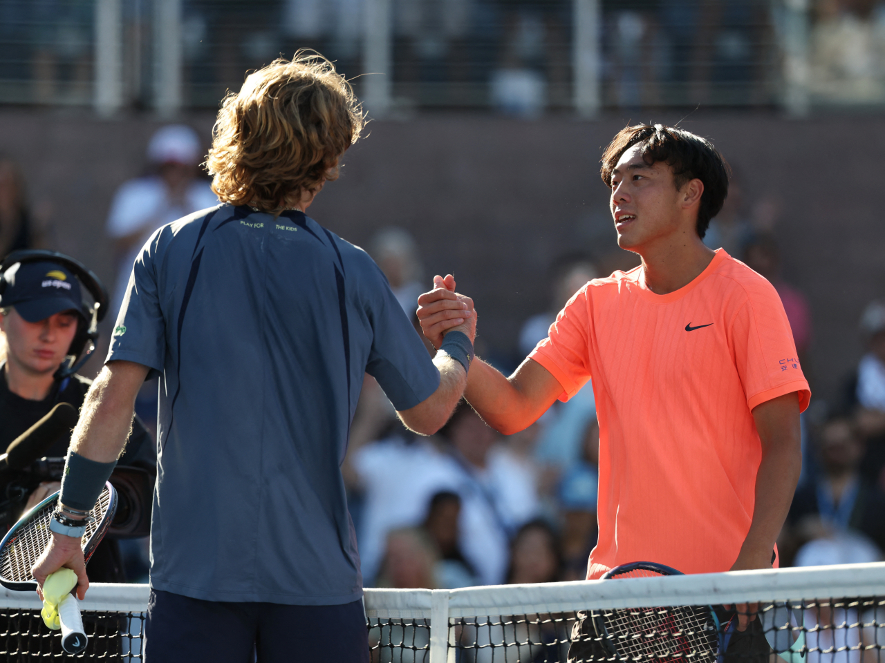 Russia's Andrey Rublev shakes hands with Coleman Wong after winning his third round match. Photo: Reuters