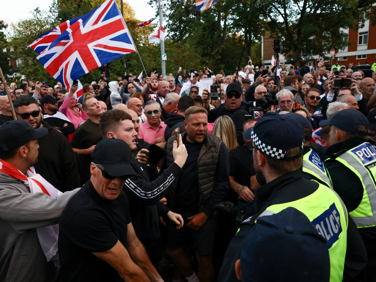 Hundreds of people gathered outside the Bell Hotel in Eppingto call for the removal of asylum seekers housed there. Photo: Reuters
