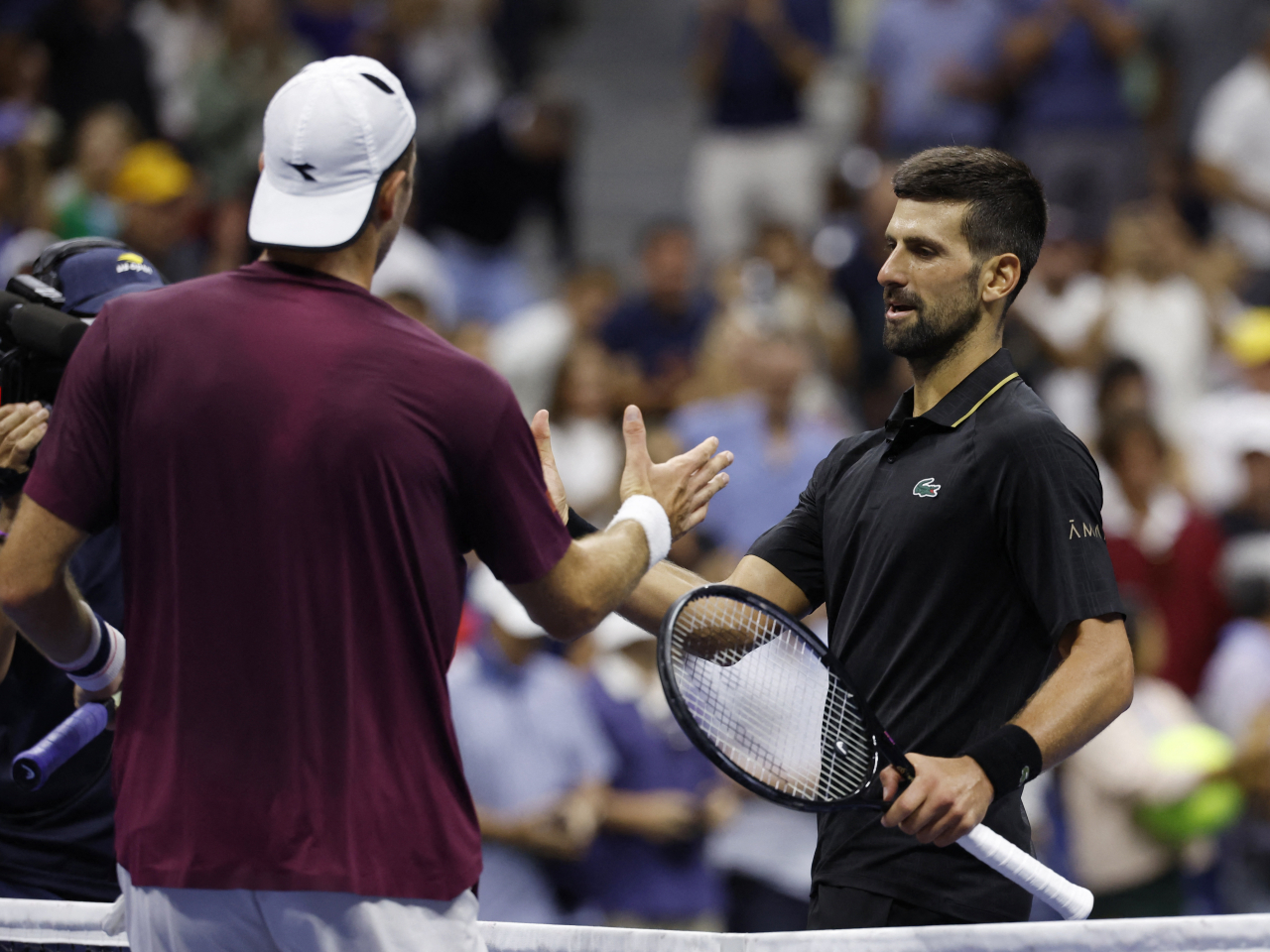 Djokovic and Germany's Jan-Lennard Struff shake hands after their fourth round clash at the Arthur Ashe Stadium. Photo: Reuters