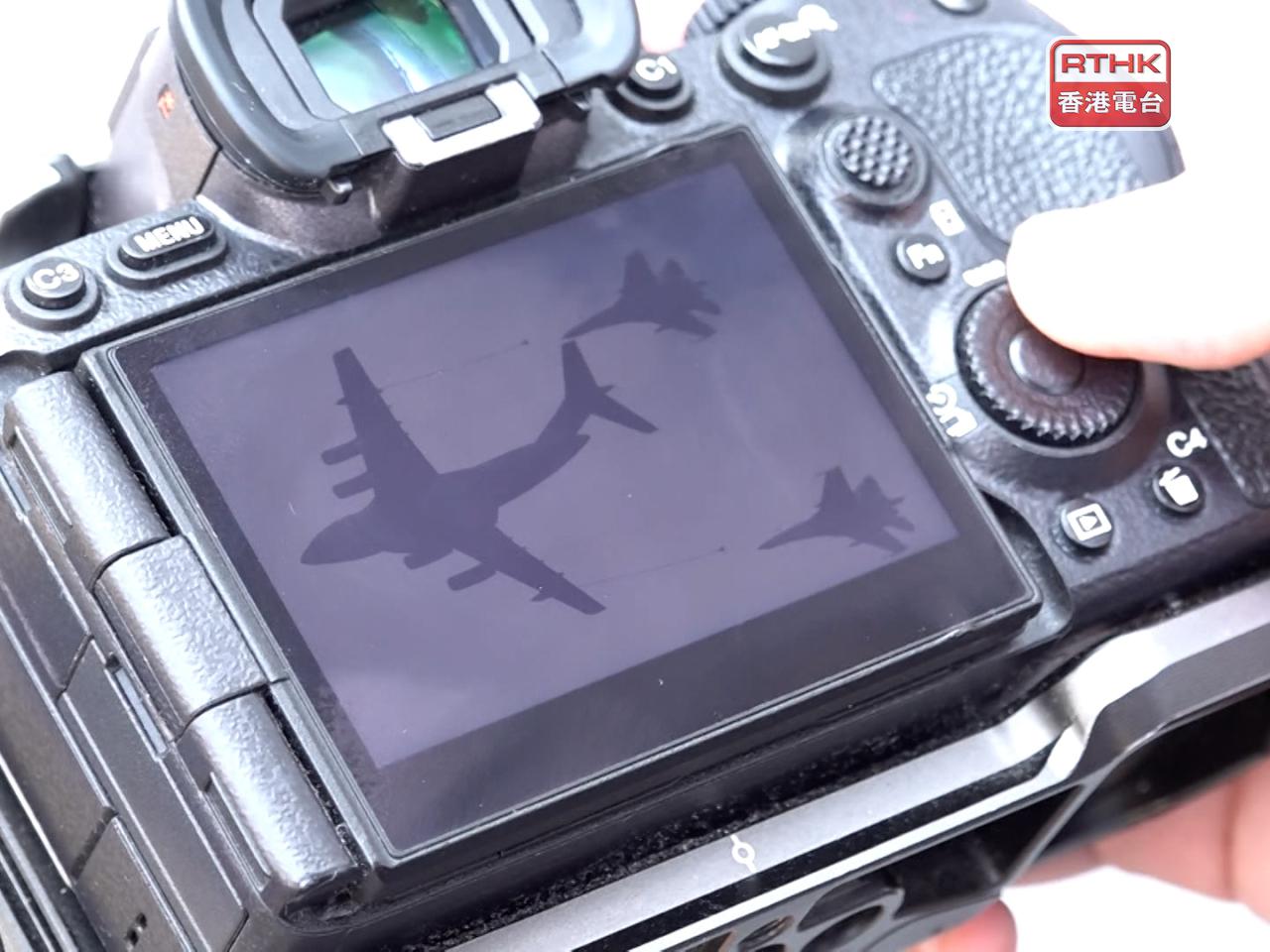 A resident showed his photographs of some aviation arms displayed during the country's September 3rd military parade on Wednesday. Photo: RTHK