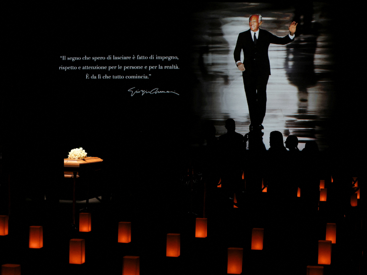 Candles surround the coffin of designer Giorgio Armani with his photo displayed behind at the Armani/Teatro as he lies in state. Photo: Reuters