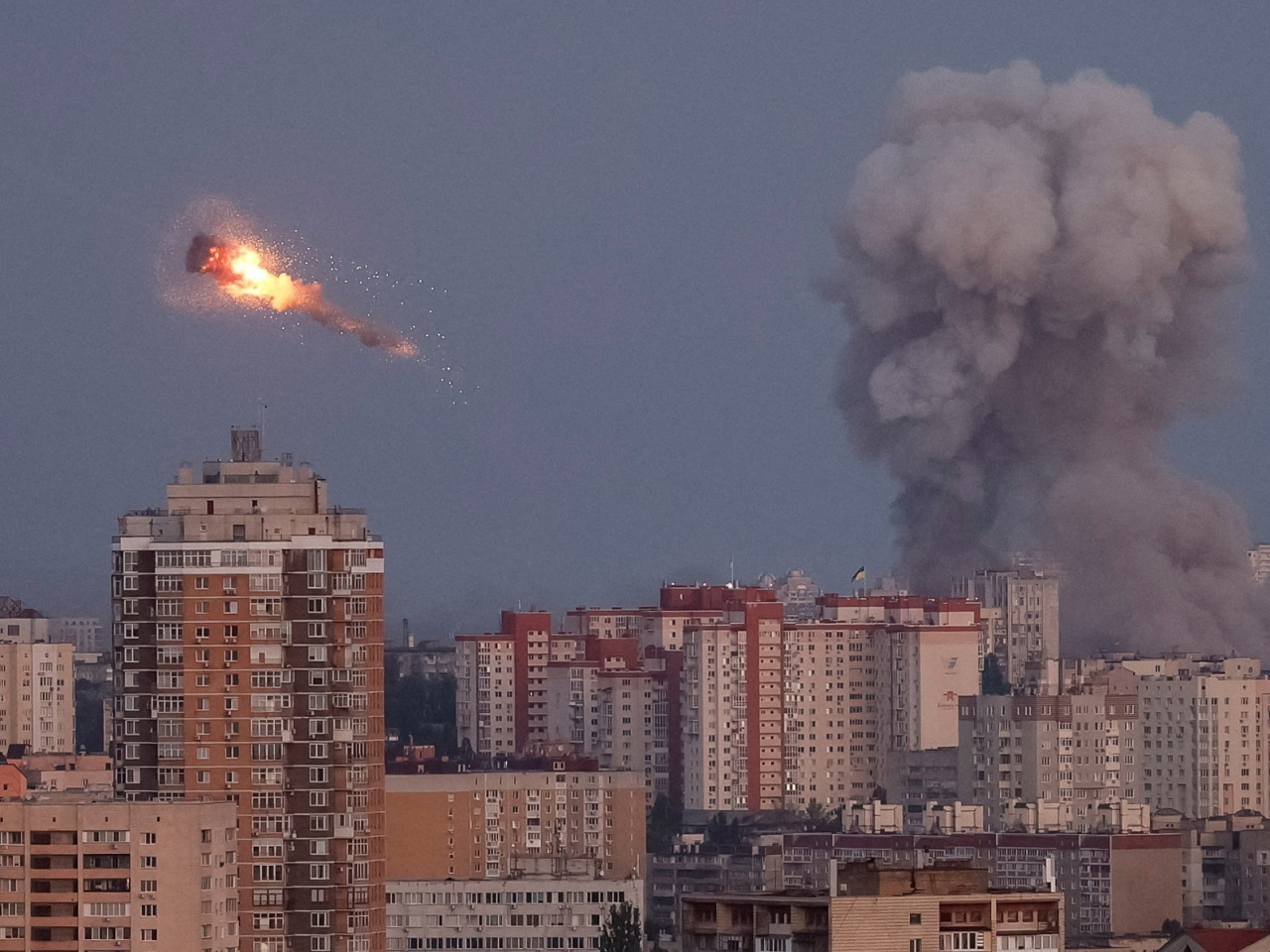Ukrainian servicemen shoot down a Russian missile as smoke rises from Kyiv during a Russian missile strike. Photo: Reuters