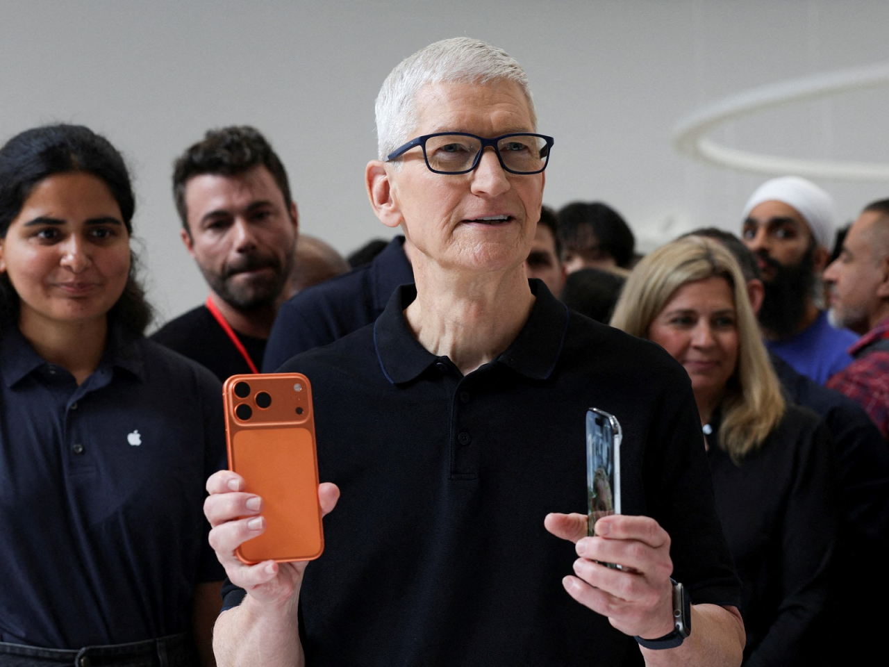 Apple CEO Tim Cook holds an iPhone 17 Pro and an iPhone Air, with prices unchanged from last year's equivalent models. Photo: Reuters